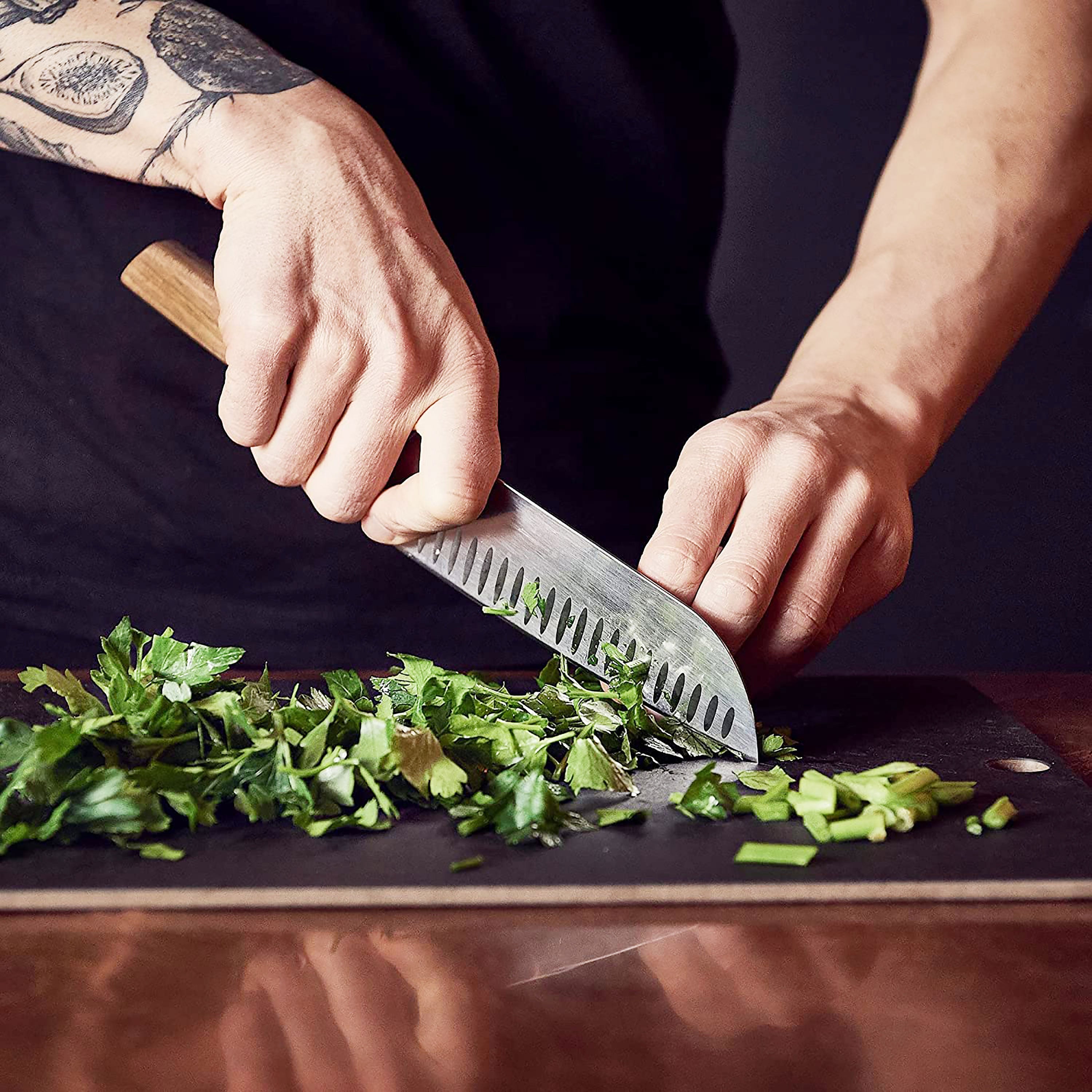 Victorinox Swiss Modern Santoku knife in a kitchen setting, demonstrating its perfect balance and ergonomic grip.