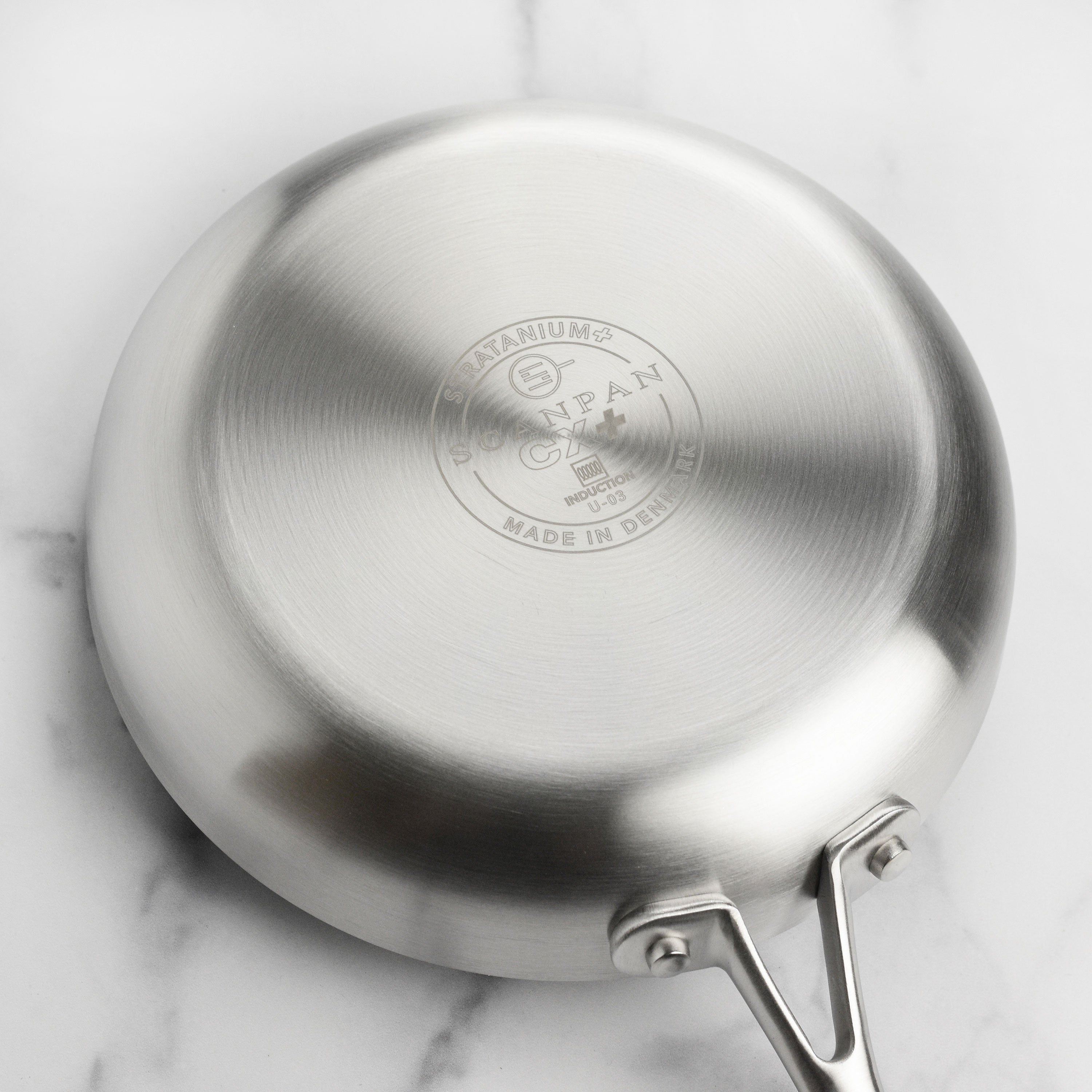 Stainless steel cookware set on a modern kitchen countertop