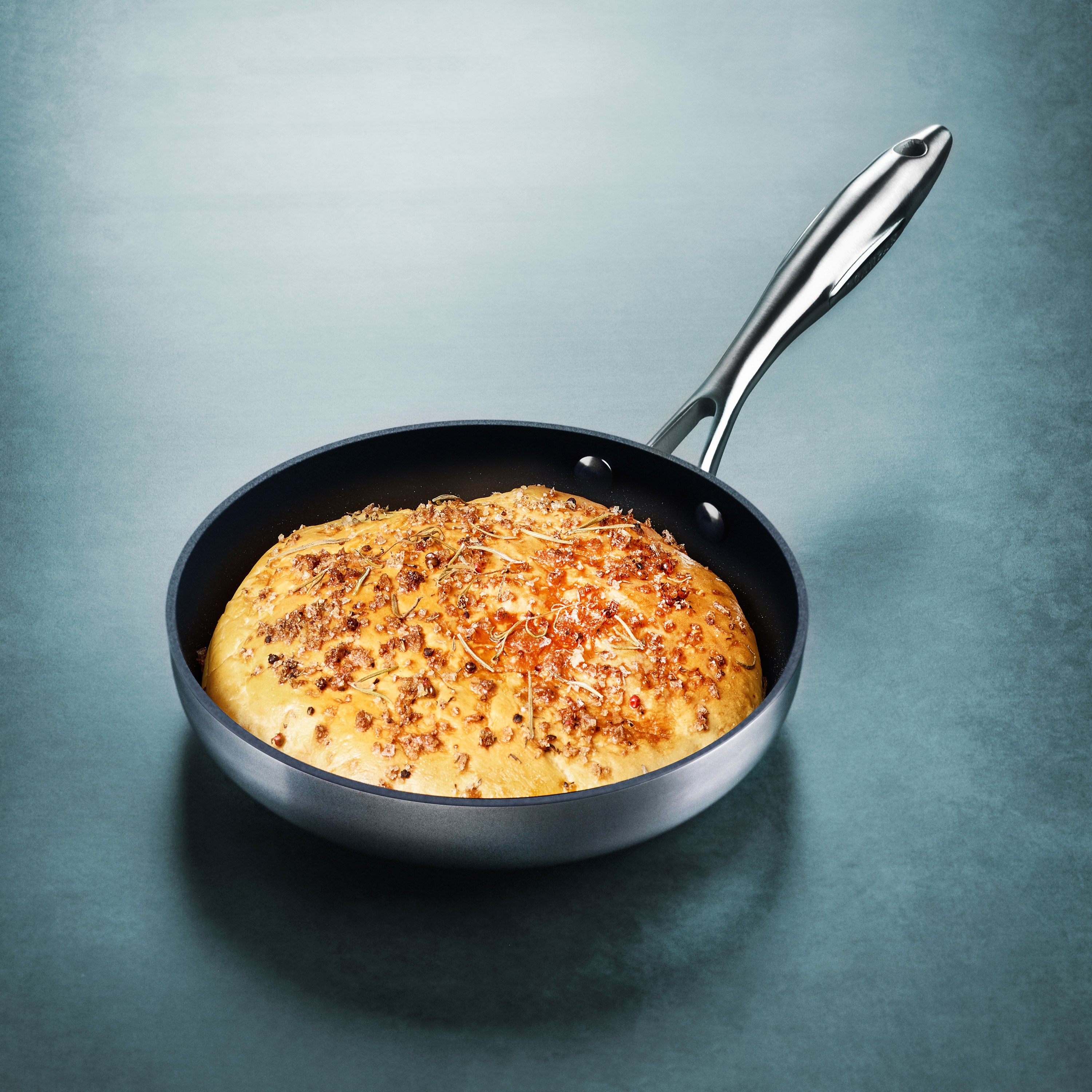 Cookware set with glass lids and stainless steel handles in a kitchen
