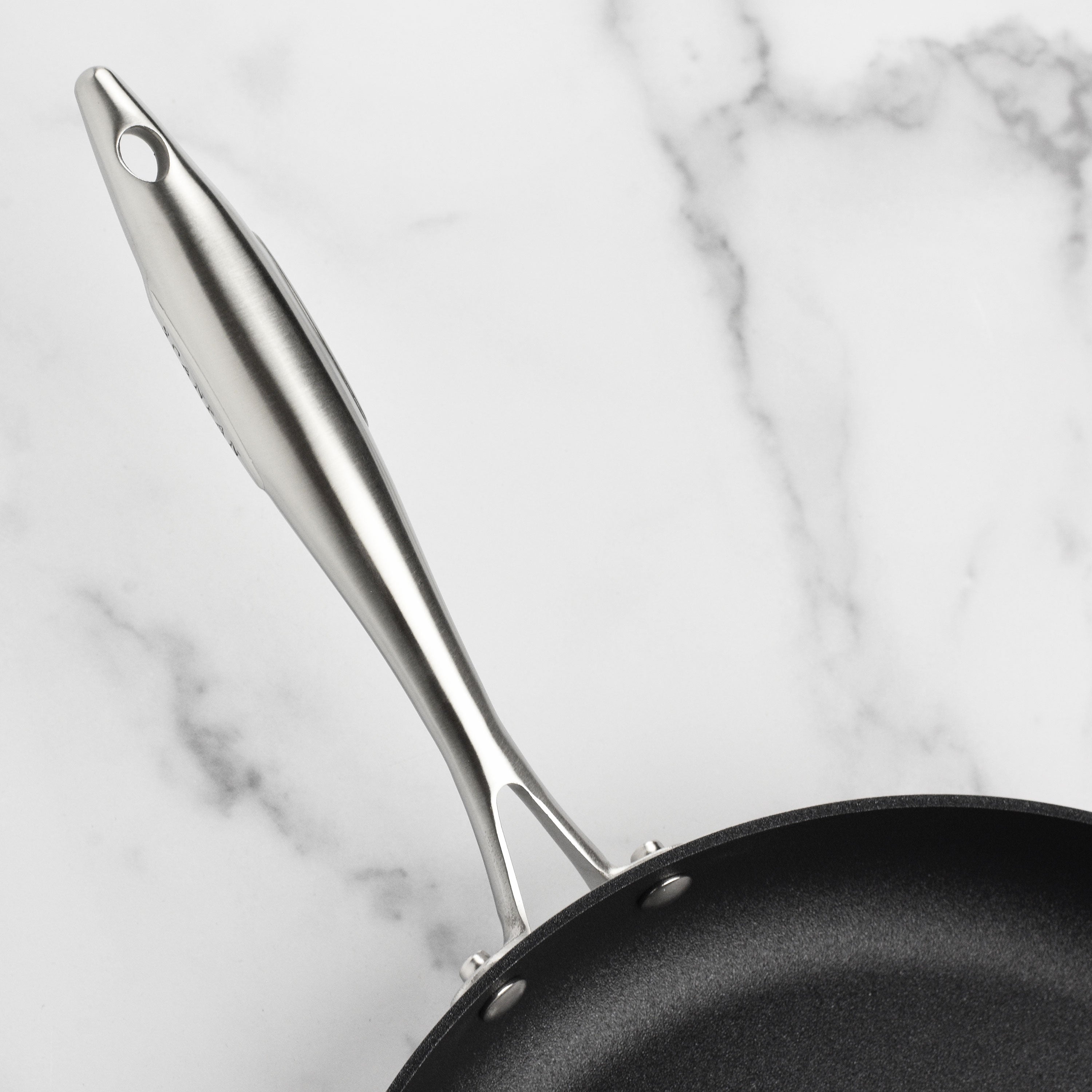 Stainless steel nonstick fry pan with lid on induction stove for even heating