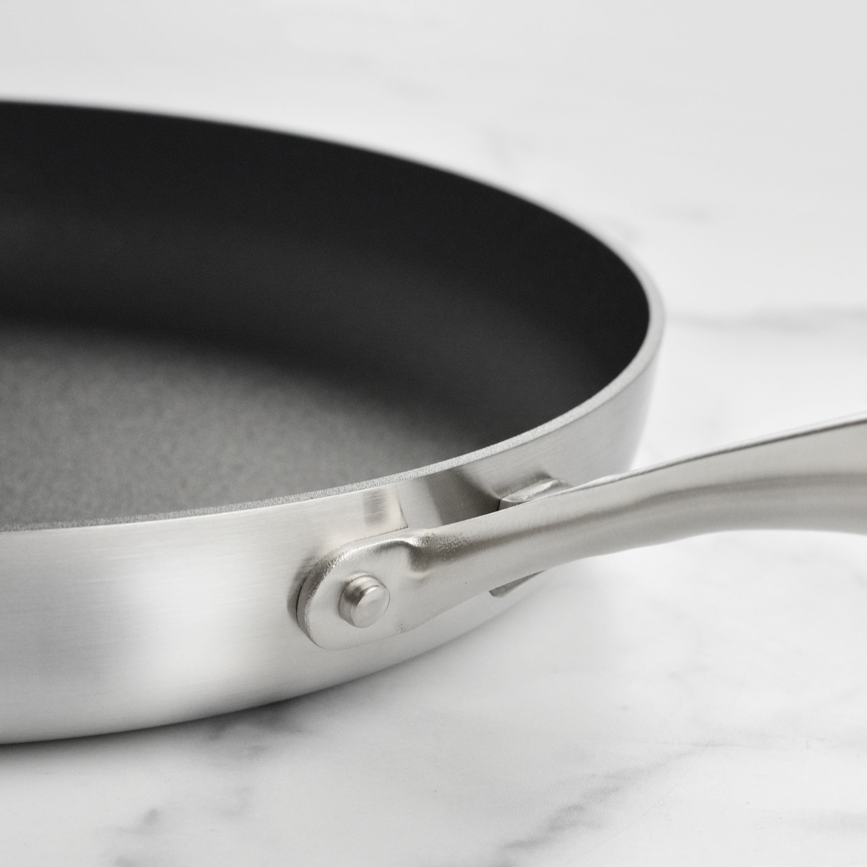 Stainless steel nonstick fry pan with lid on induction stove for even heating