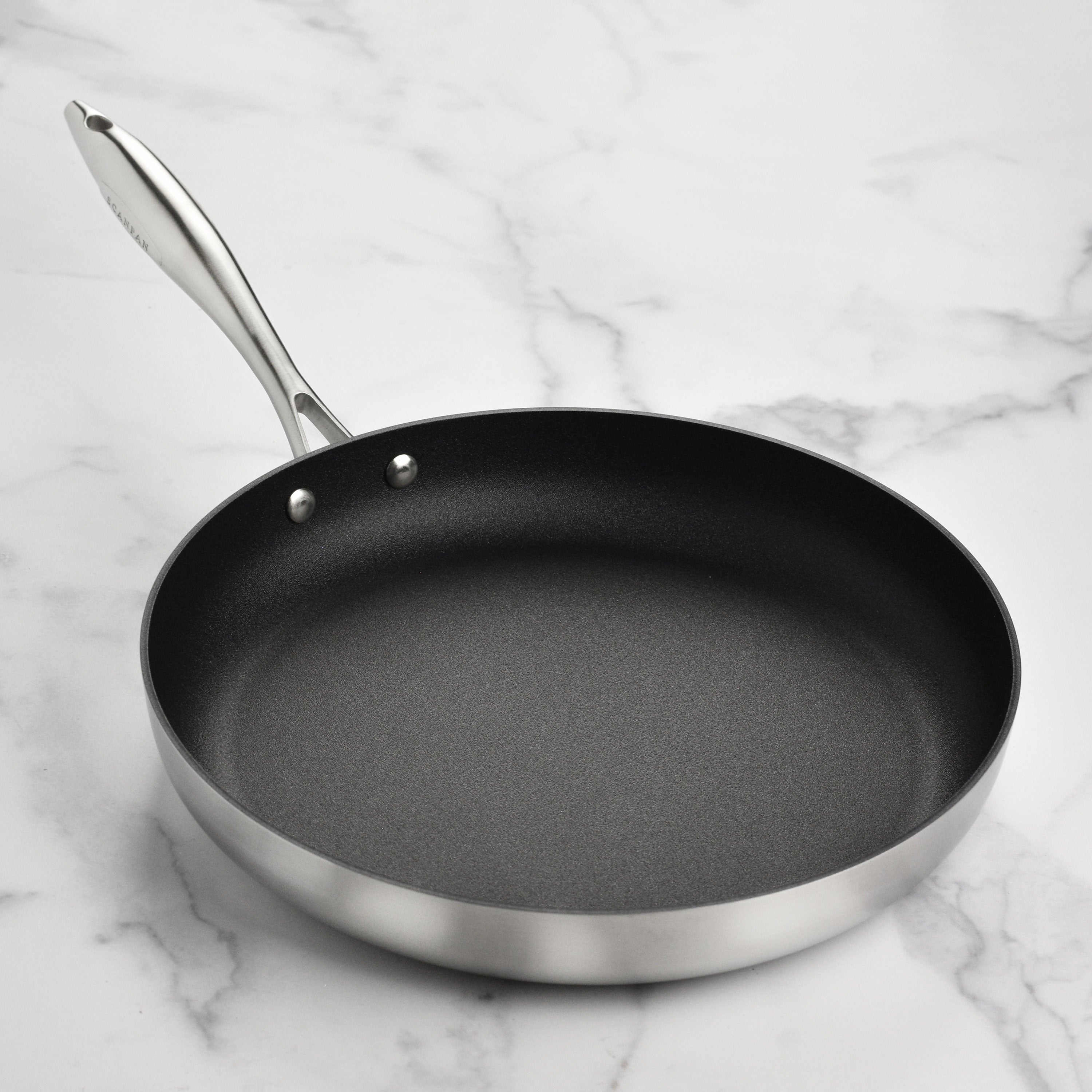 Cast stainless steel handle on nonstick fry pan with lid for safe handling
