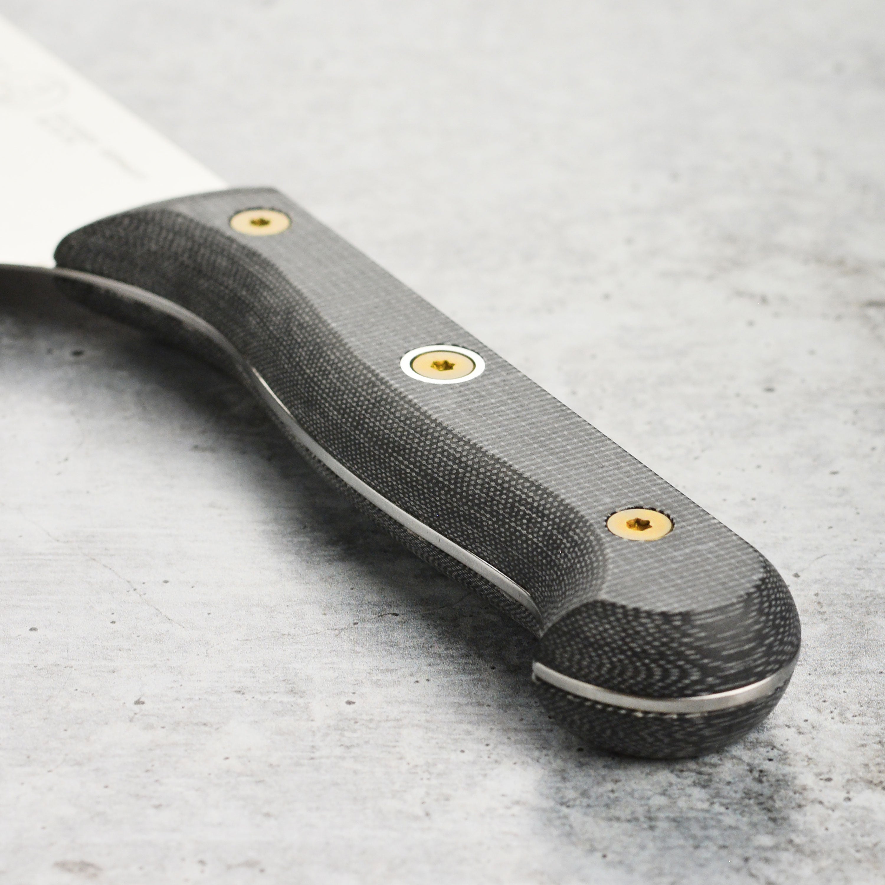 The Nakiri knife in action, effortlessly slicing fresh vegetables on a wooden cutting board.