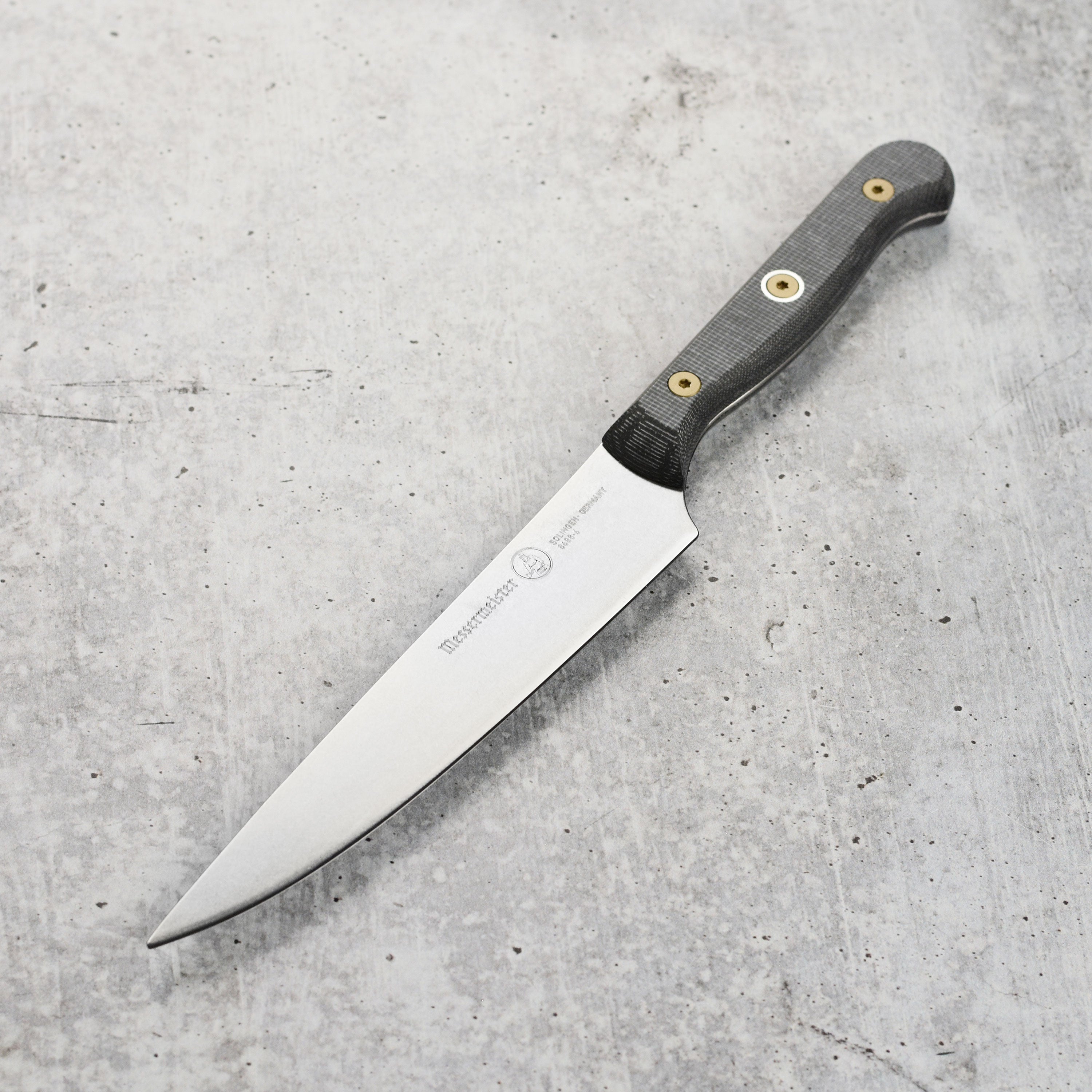 Close-up of Messermeister Custom Micarta 6-Inch Utility Knife displaying its stainless steel blade and unique handle texture.