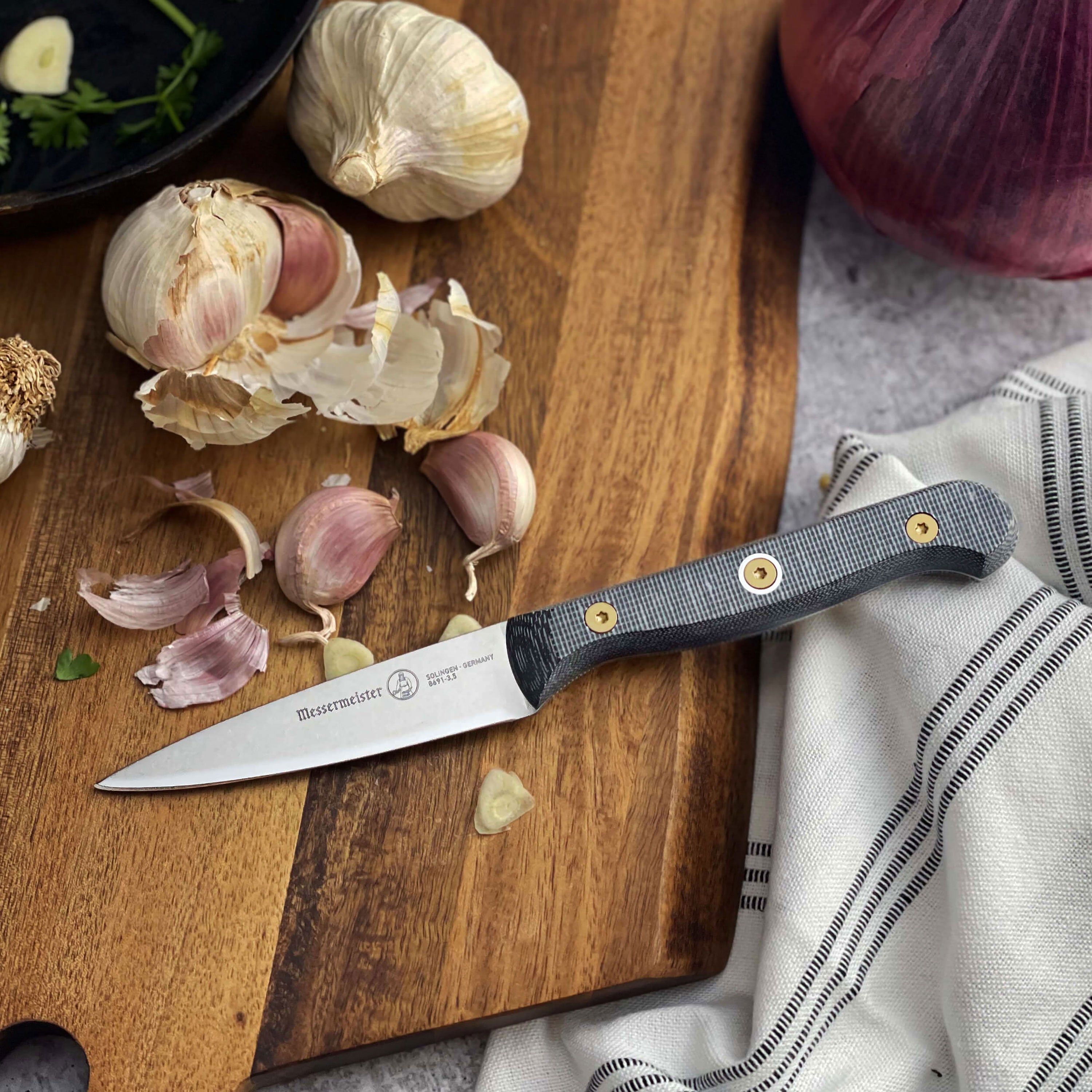 Close-up of the Messermeister Micarta 3.5" paring knife highlighting the stainless steel blade and ergonomic handle.