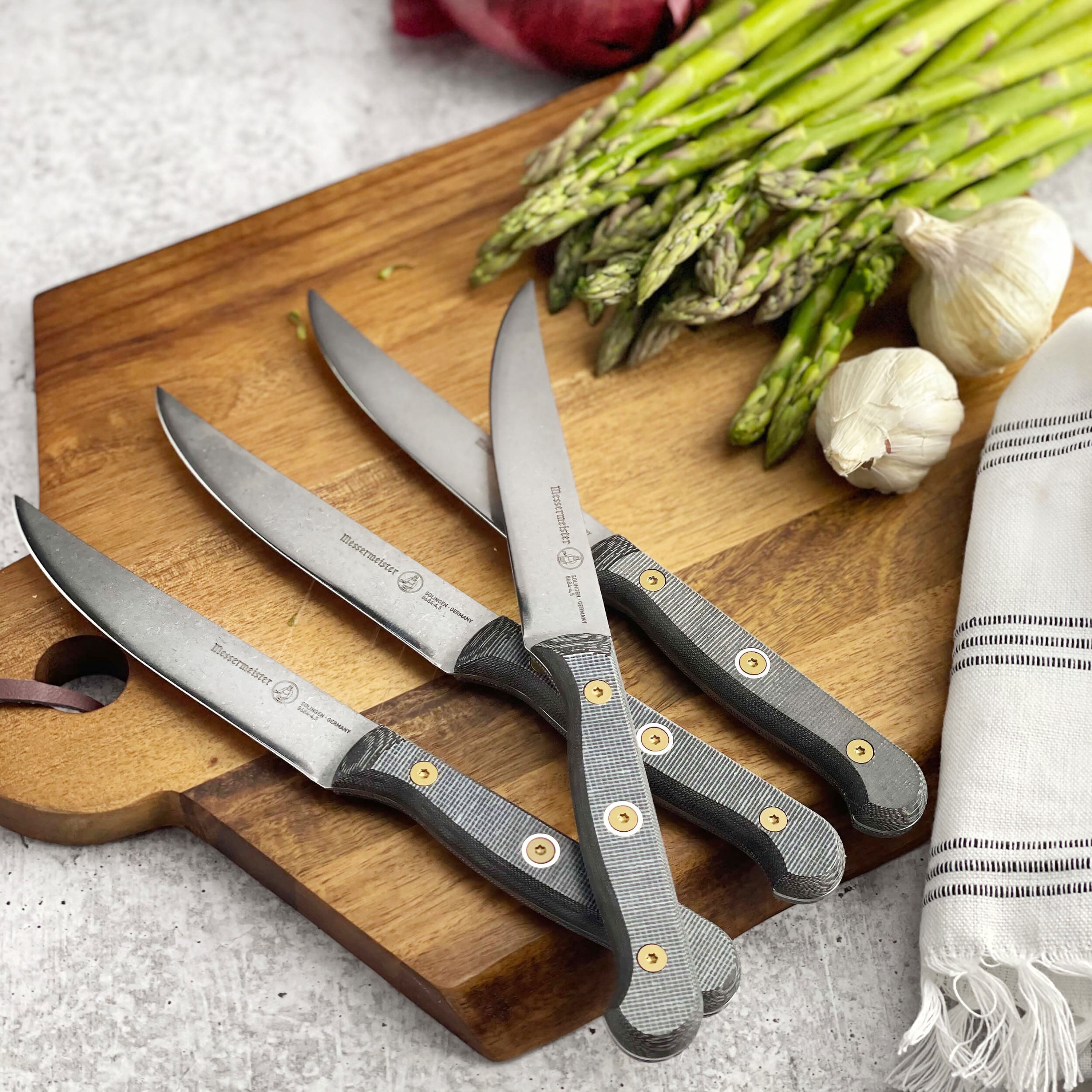 Chef using Messermeister steak knives for perfect slicing on a dinner plate