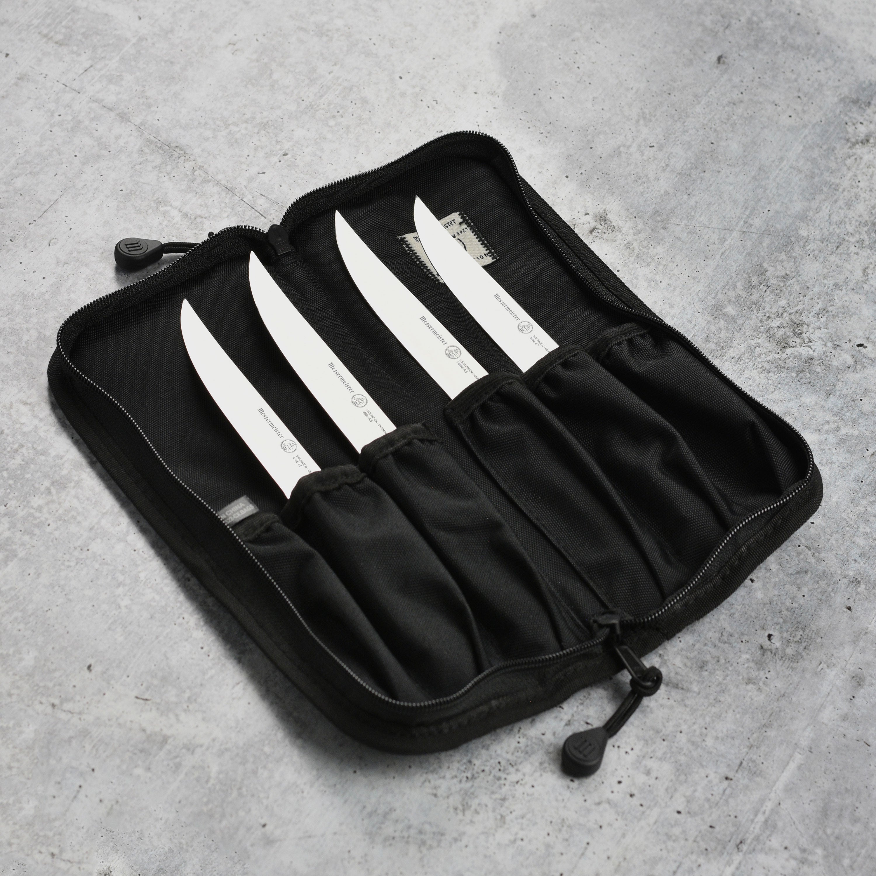 Set of four premium kitchen knives with stainless steel blades and ergonomic handles