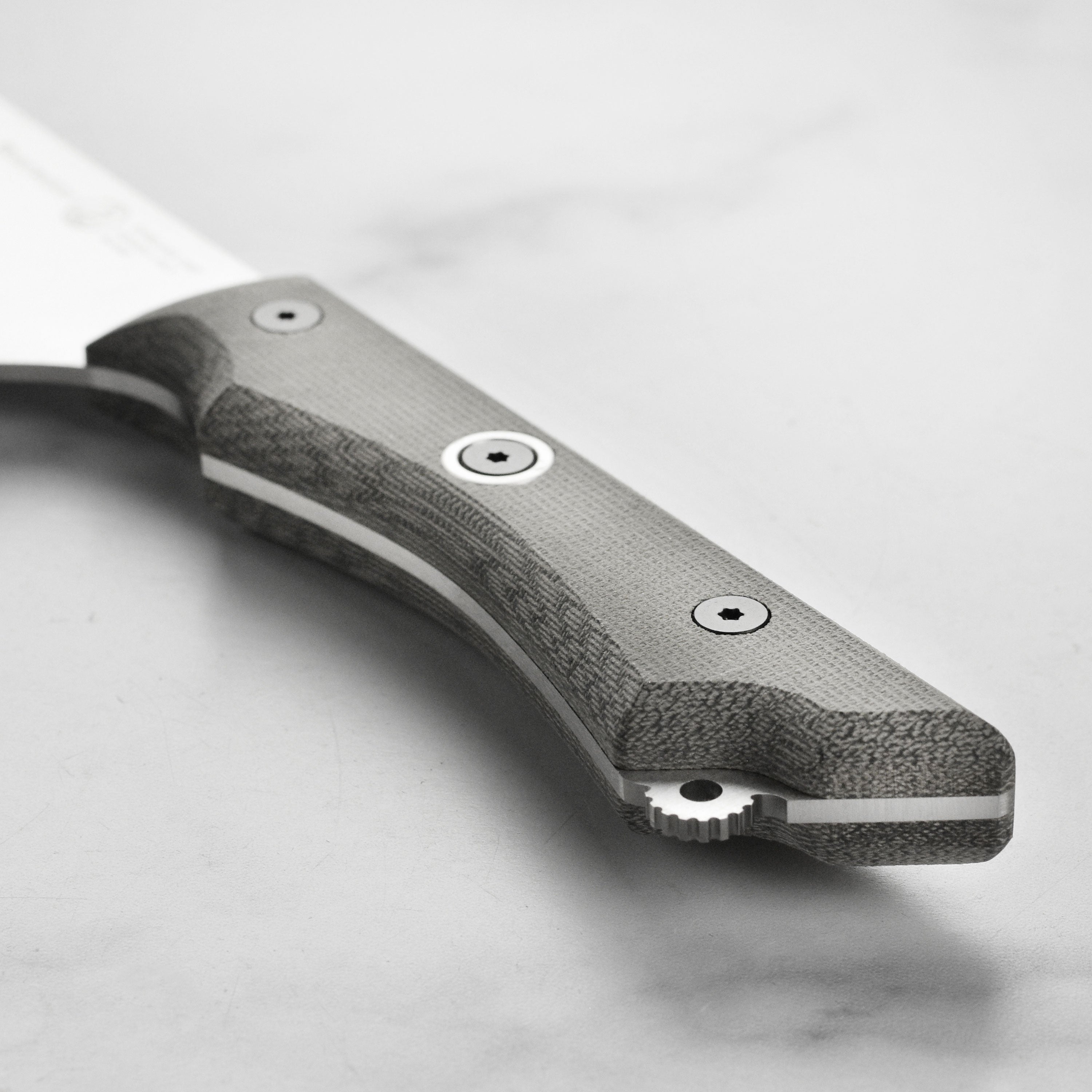 Side view of the knife highlighting the textured Micarta handle