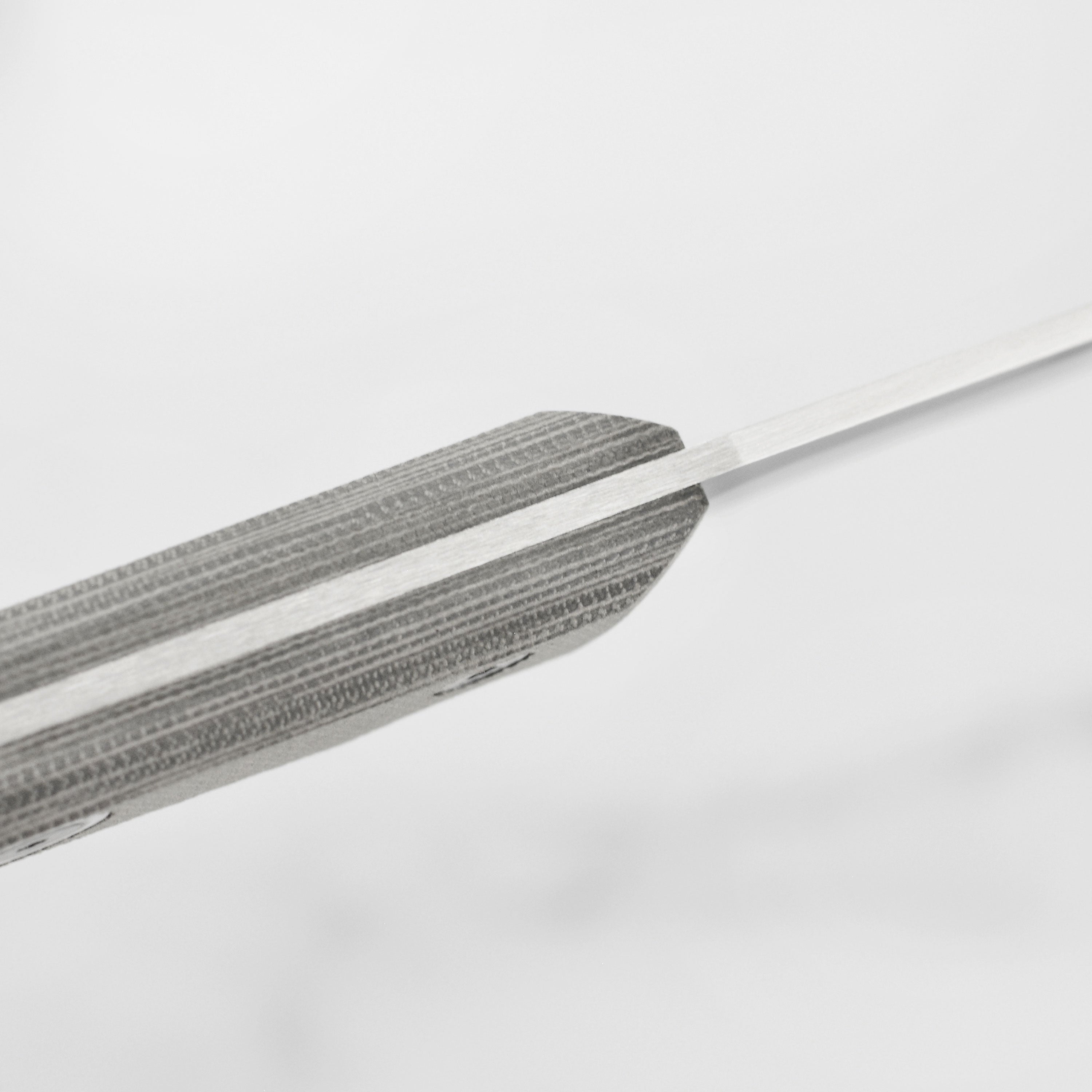Close-up of the 4.5-inch utility knifes ballistic clip point blade