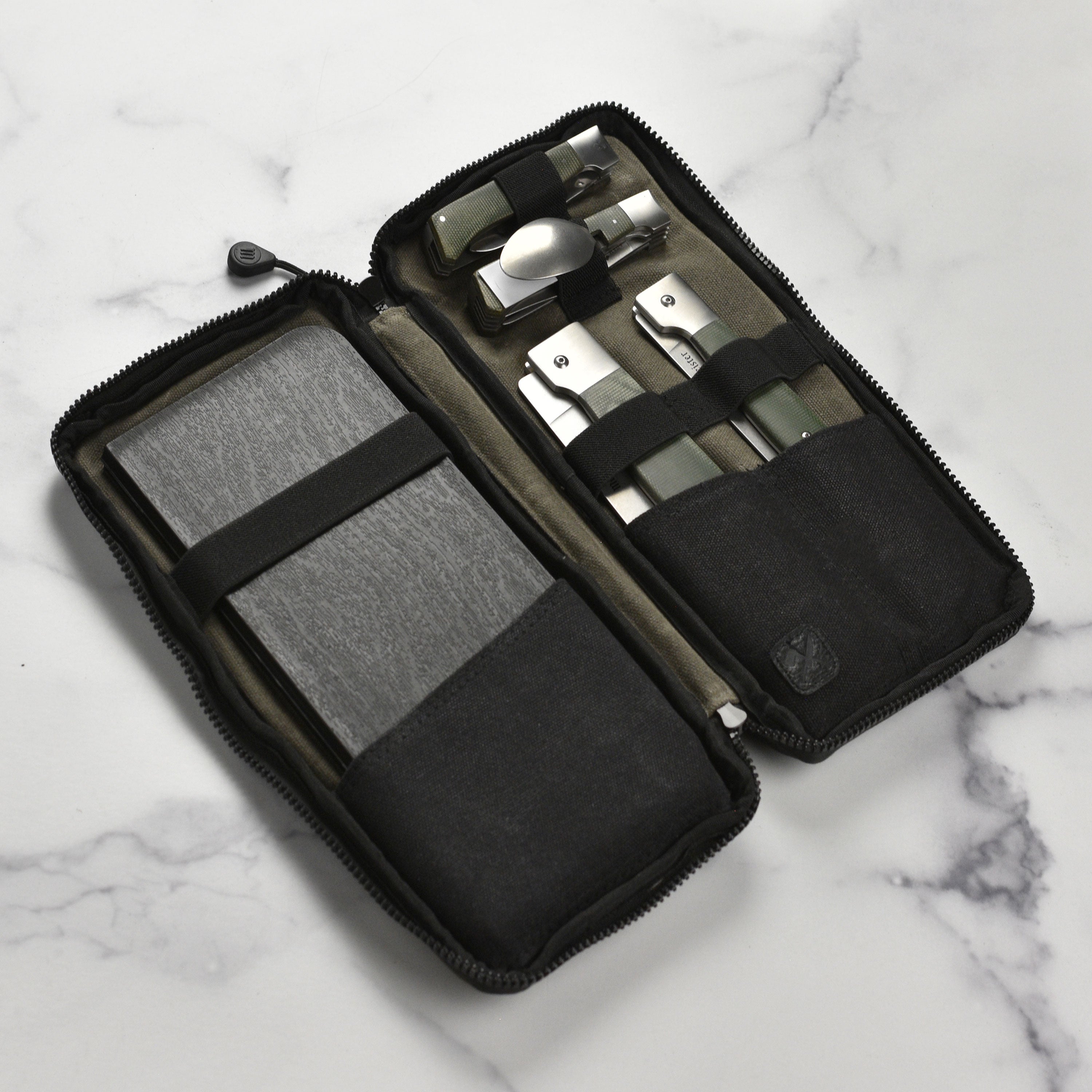 Top-down view of the best chef knife set for camping laid out beside portable cookware.
