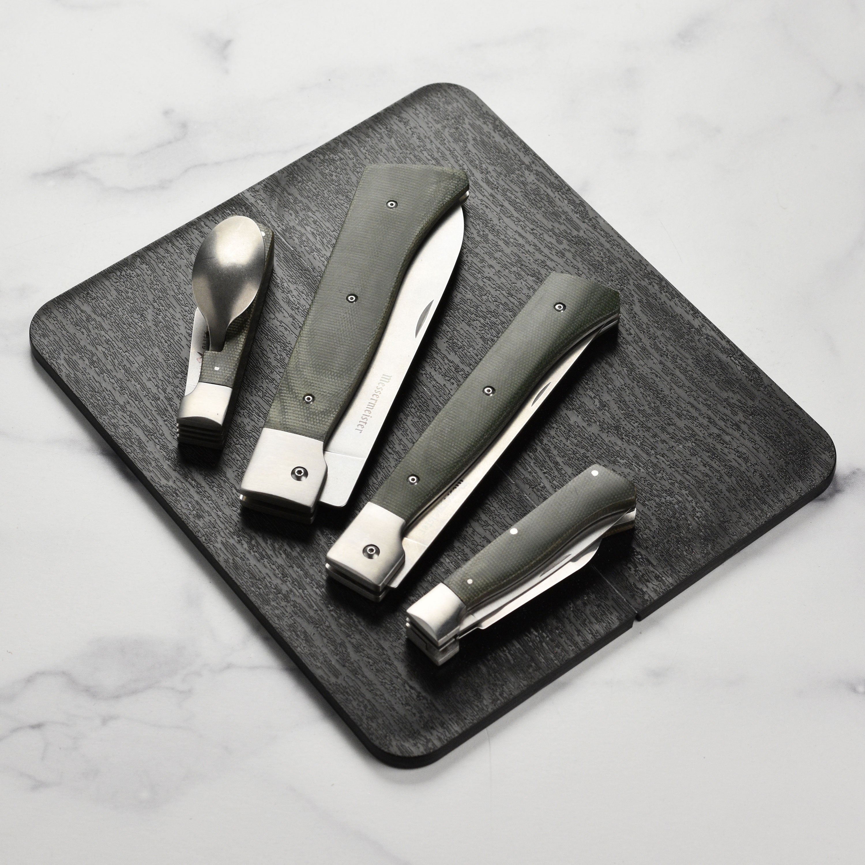 Close-up of the folding kitchen knife showing stonewash blade finish and linen handle.