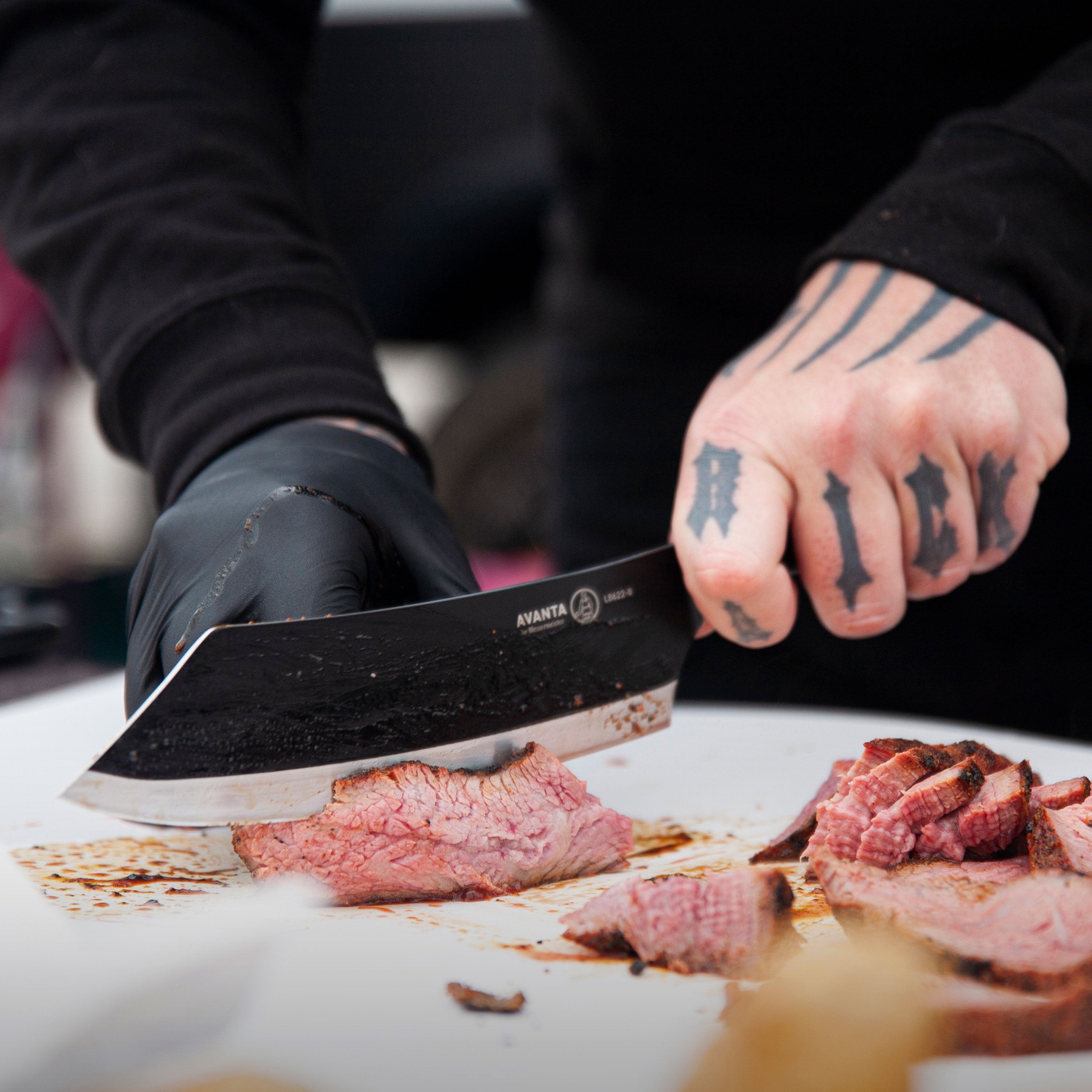 Chef using the 8-inch BBQ knife to prepare meat on a grill