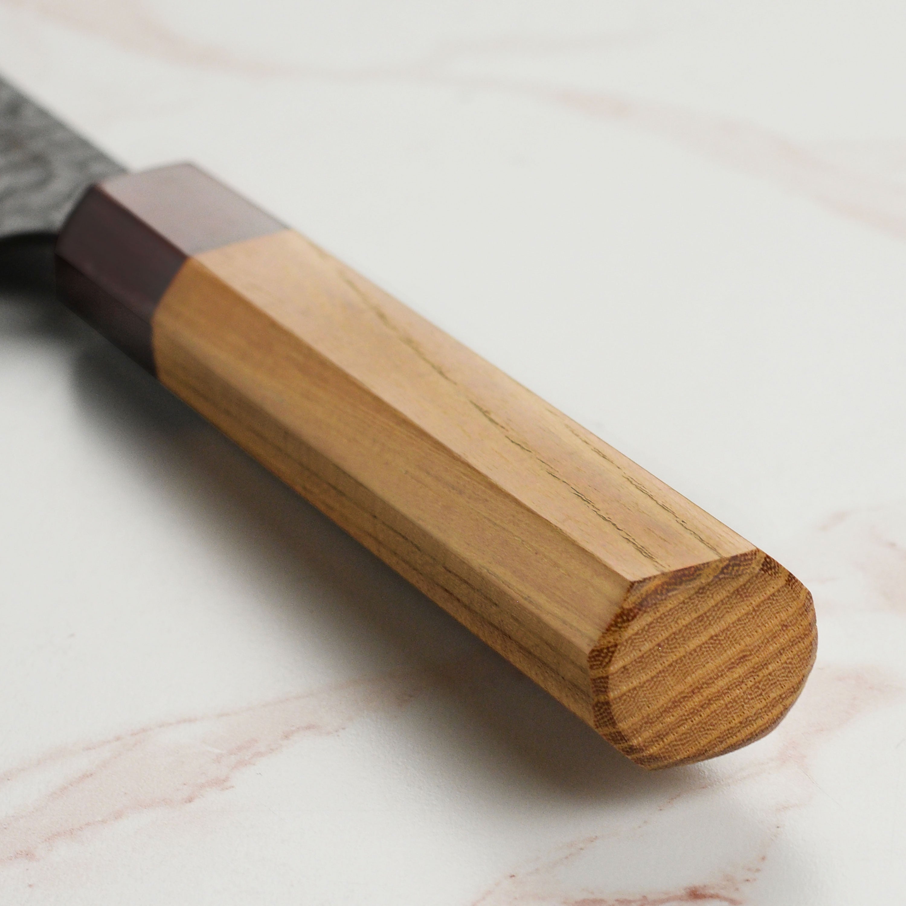 Takayuki petty knife in use, chopping vegetables on a wooden cutting board