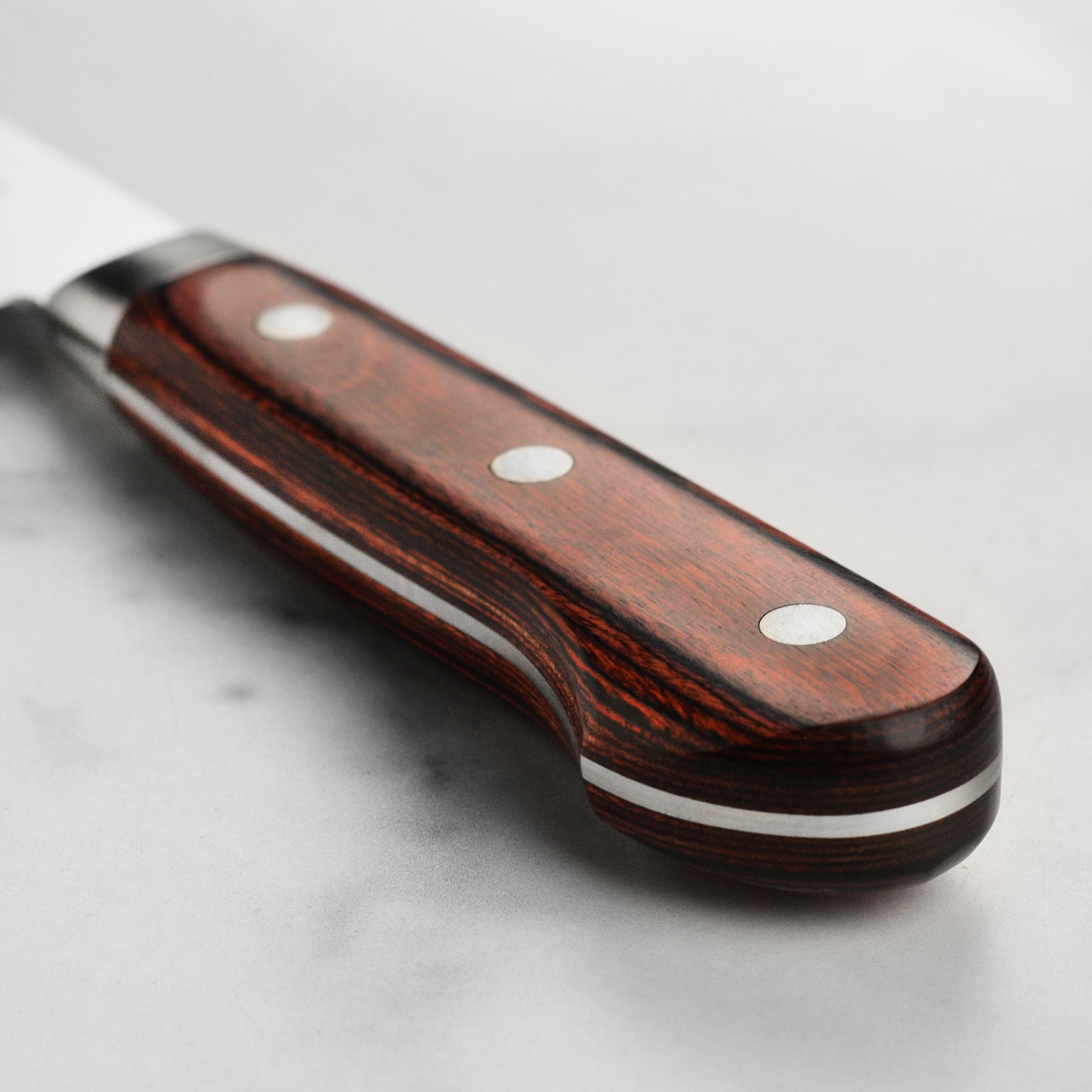 Close-up of the AUS10 stainless steel blade highlighting the intricate craftsmanship.