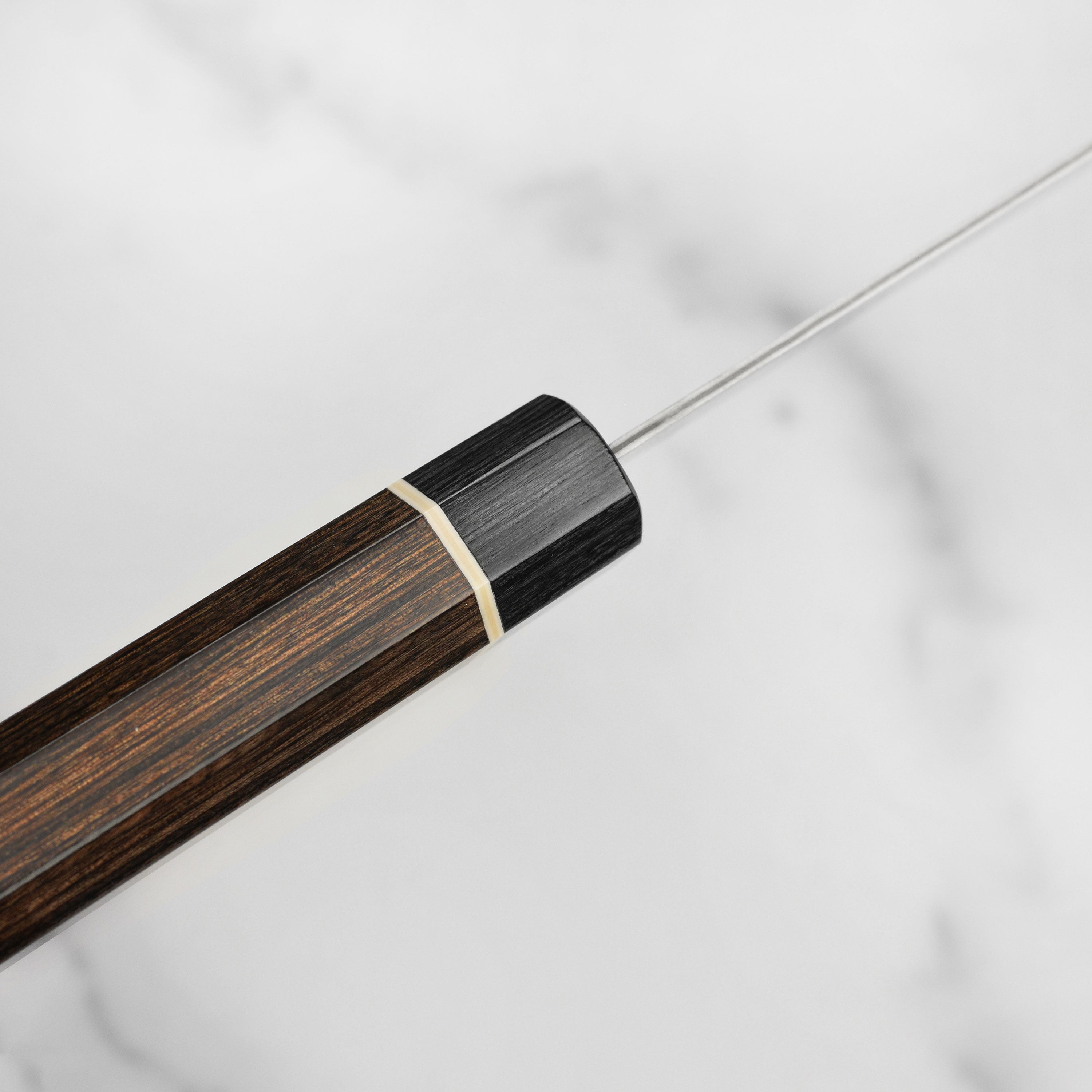 Close-up of the Pakkawood handle and blade craftsmanship of the Damascus knife