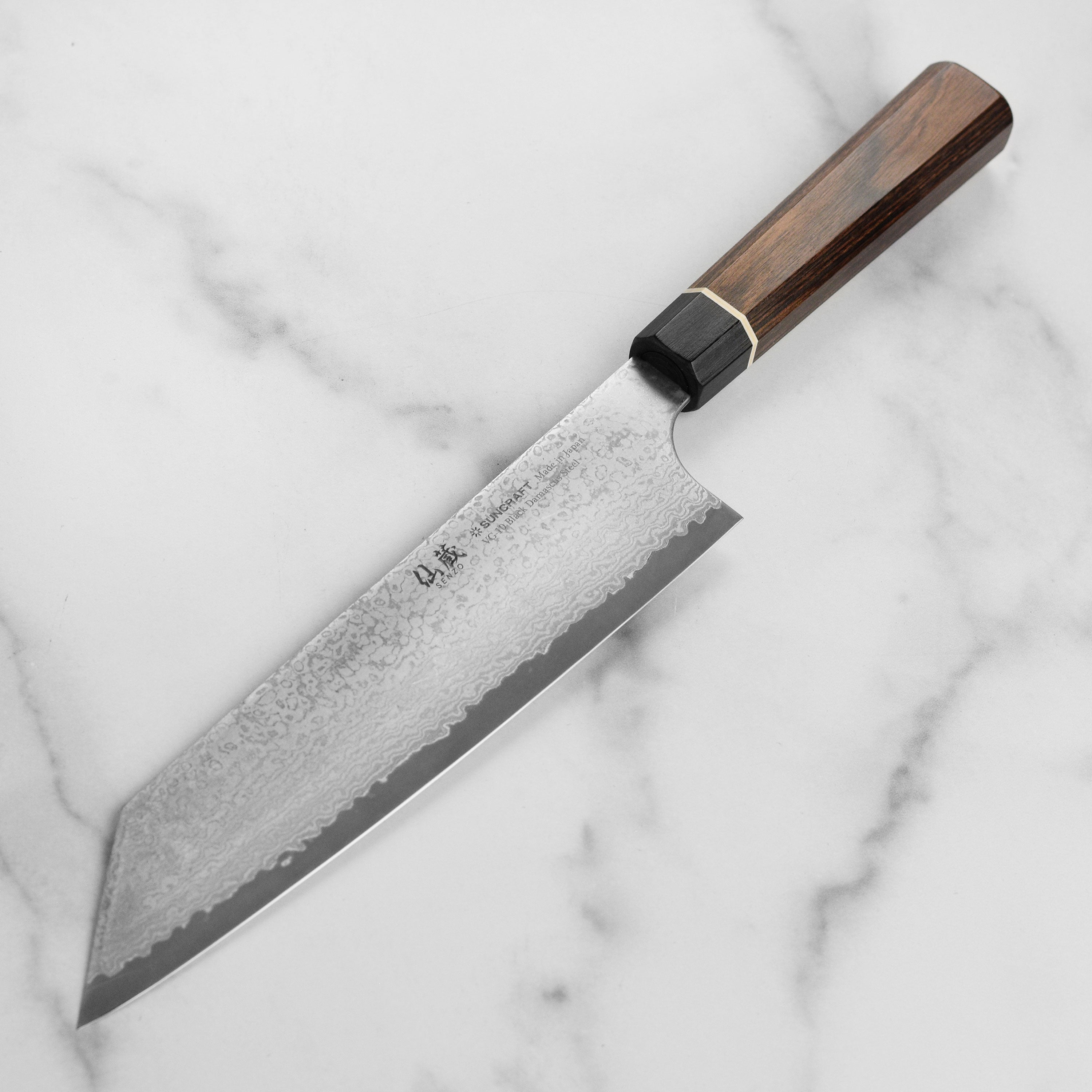 Chef slicing vegetables with the Japanese Kiritsuke knife in a professional kitchen