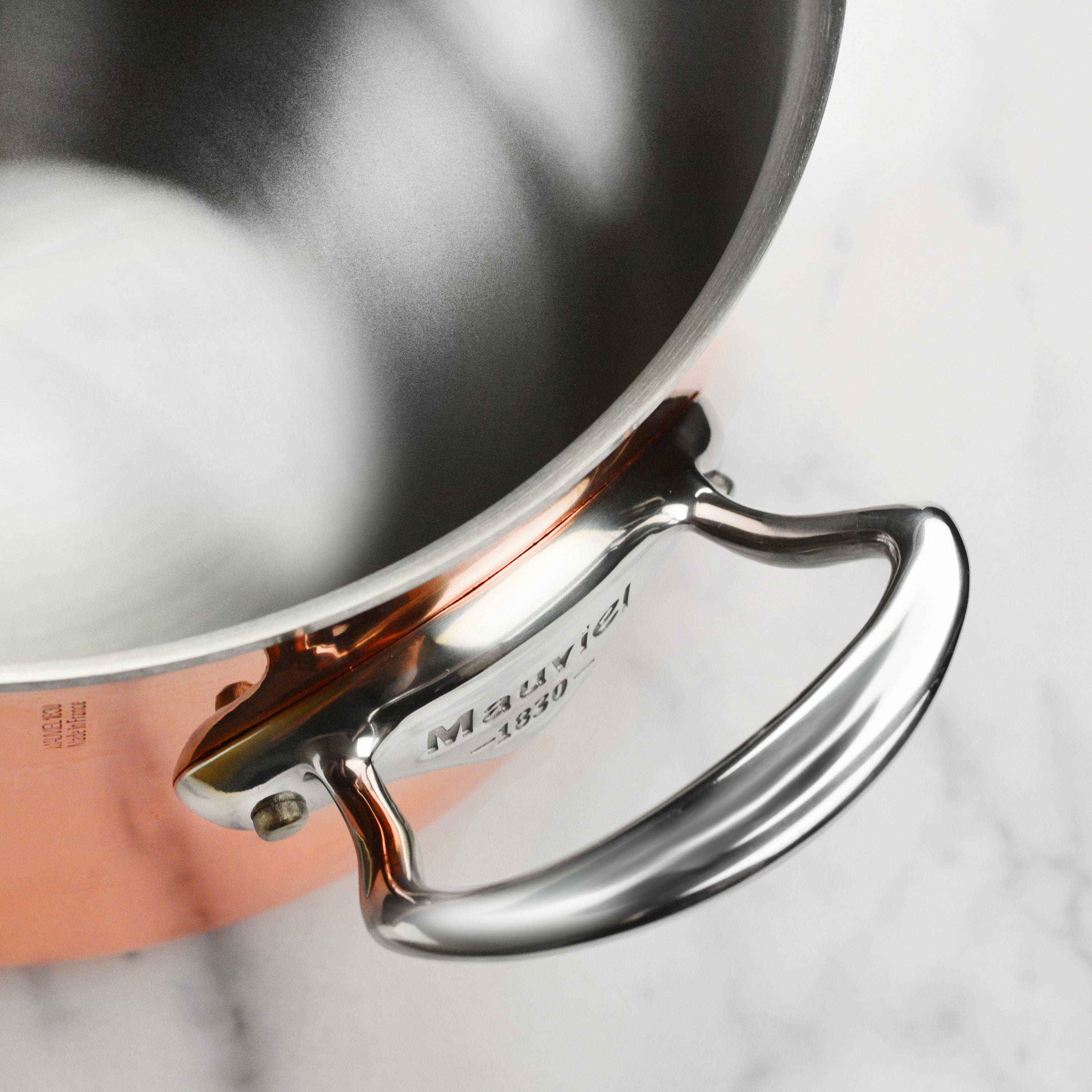 Mauviel M6S copper frying pan highlighting its sleek design and sturdy handle