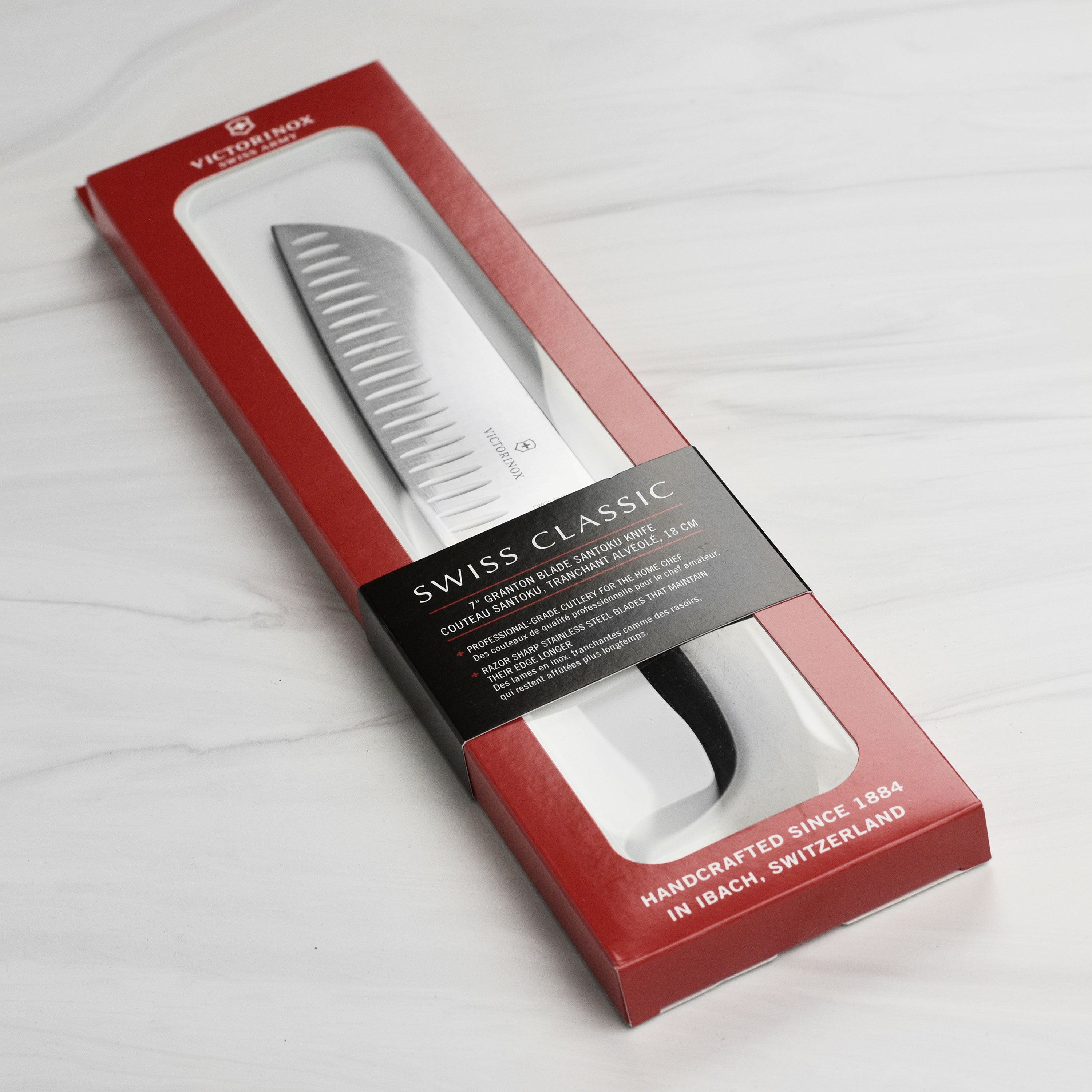 Victorinox Swiss Classic Santoku knife with hollow edge on a cutting board