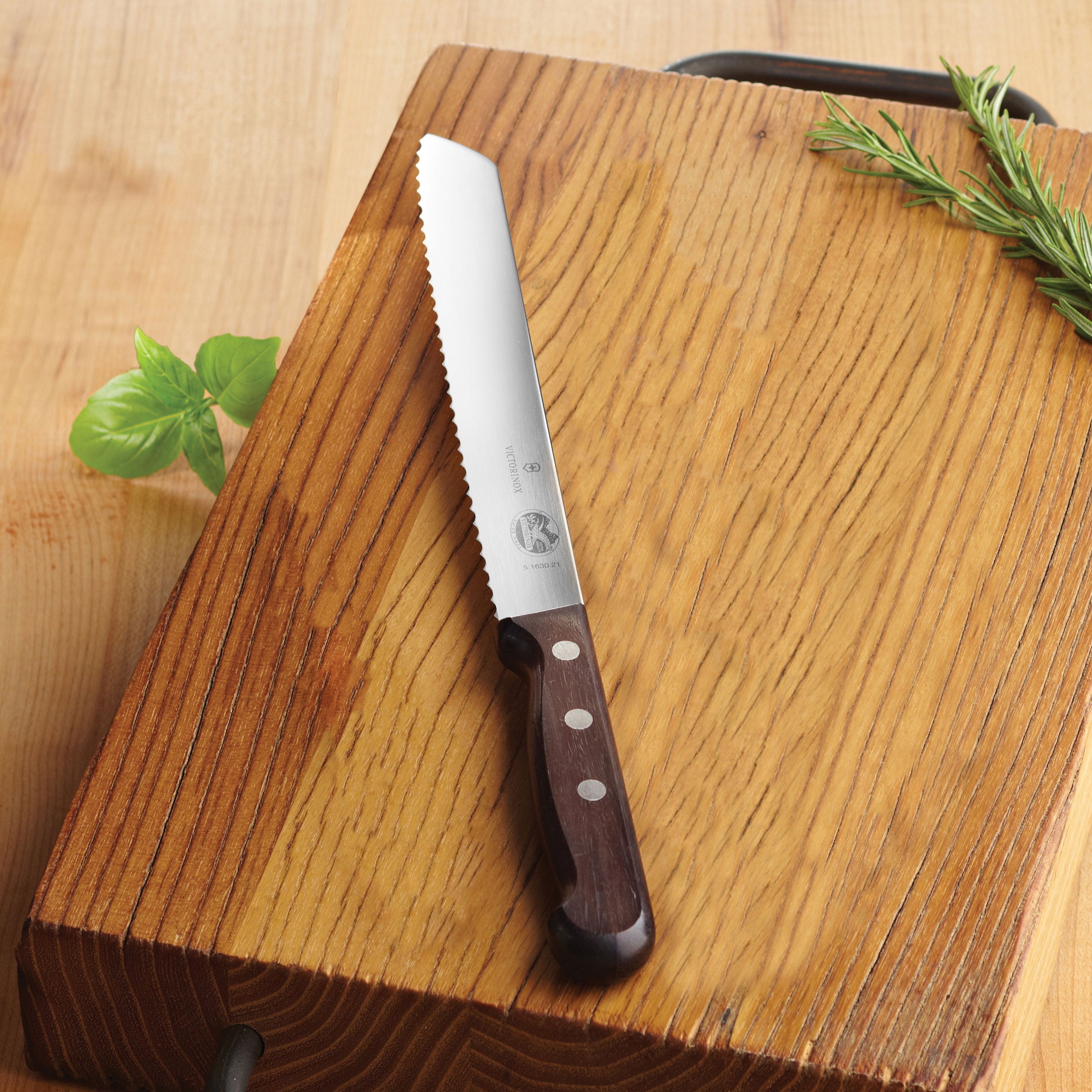 Elegant Swiss-made Victorinox bread knife with wooden handle resting on a countertop