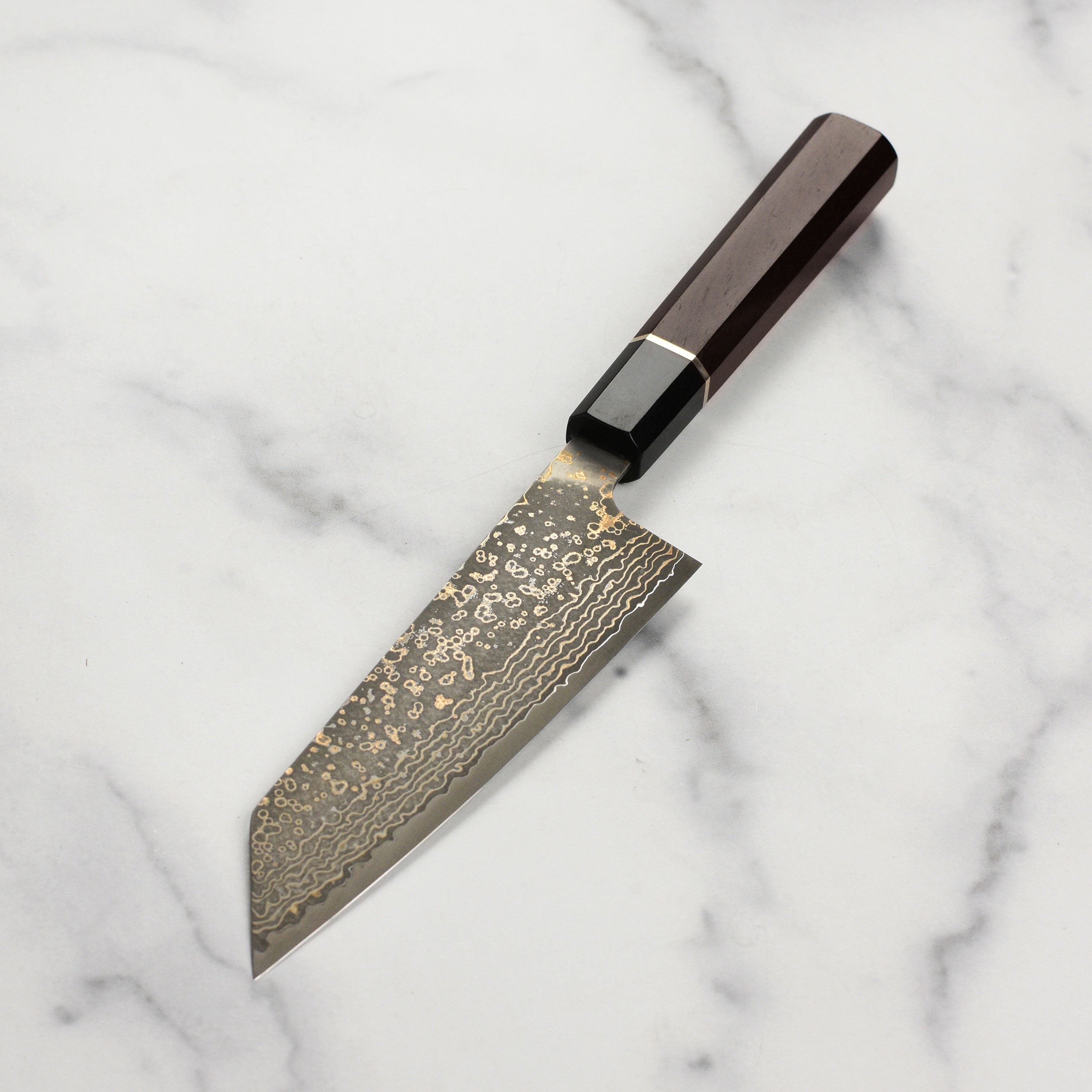 Elegant presentation of the Saji Damascus knife in its wooden gift box, perfect for gift-giving.