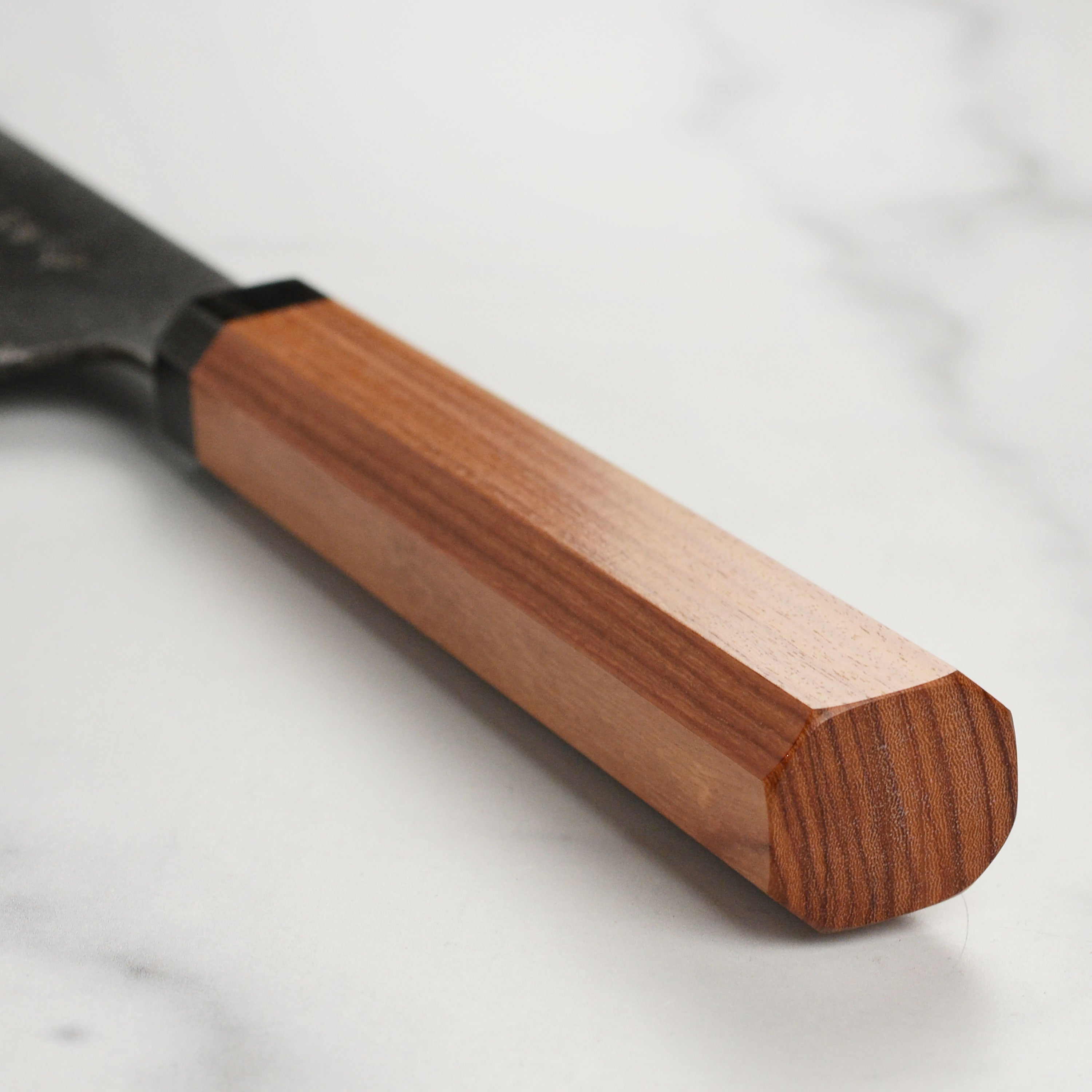 Side view of the Takayuki Bunka knife displaying the beautiful Bubinga wood handle and ebony tsuba ring.