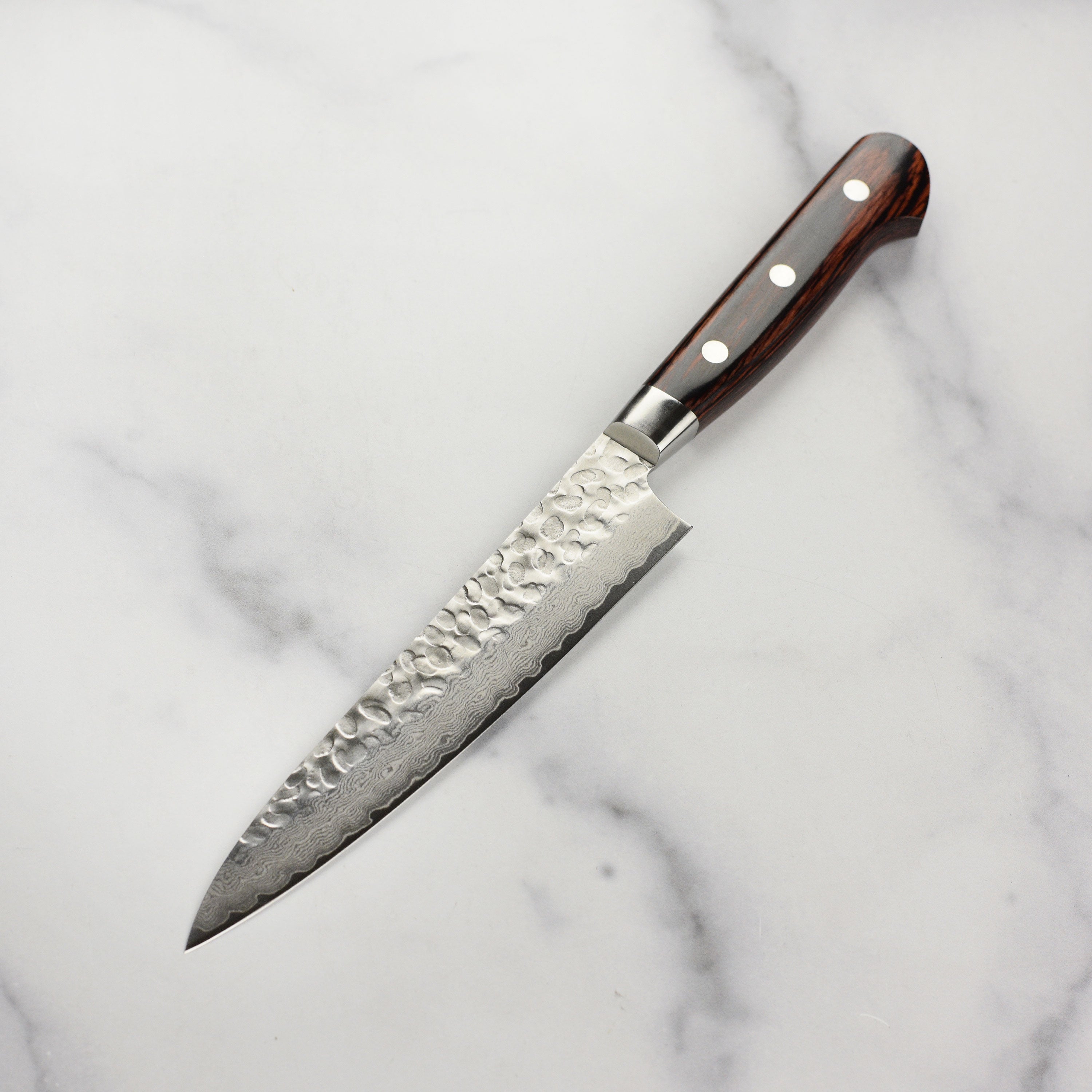 Elegant display of the Sakai Mastercraft Damascus petty knife, emphasizing its mahogany Pakkawood handle.