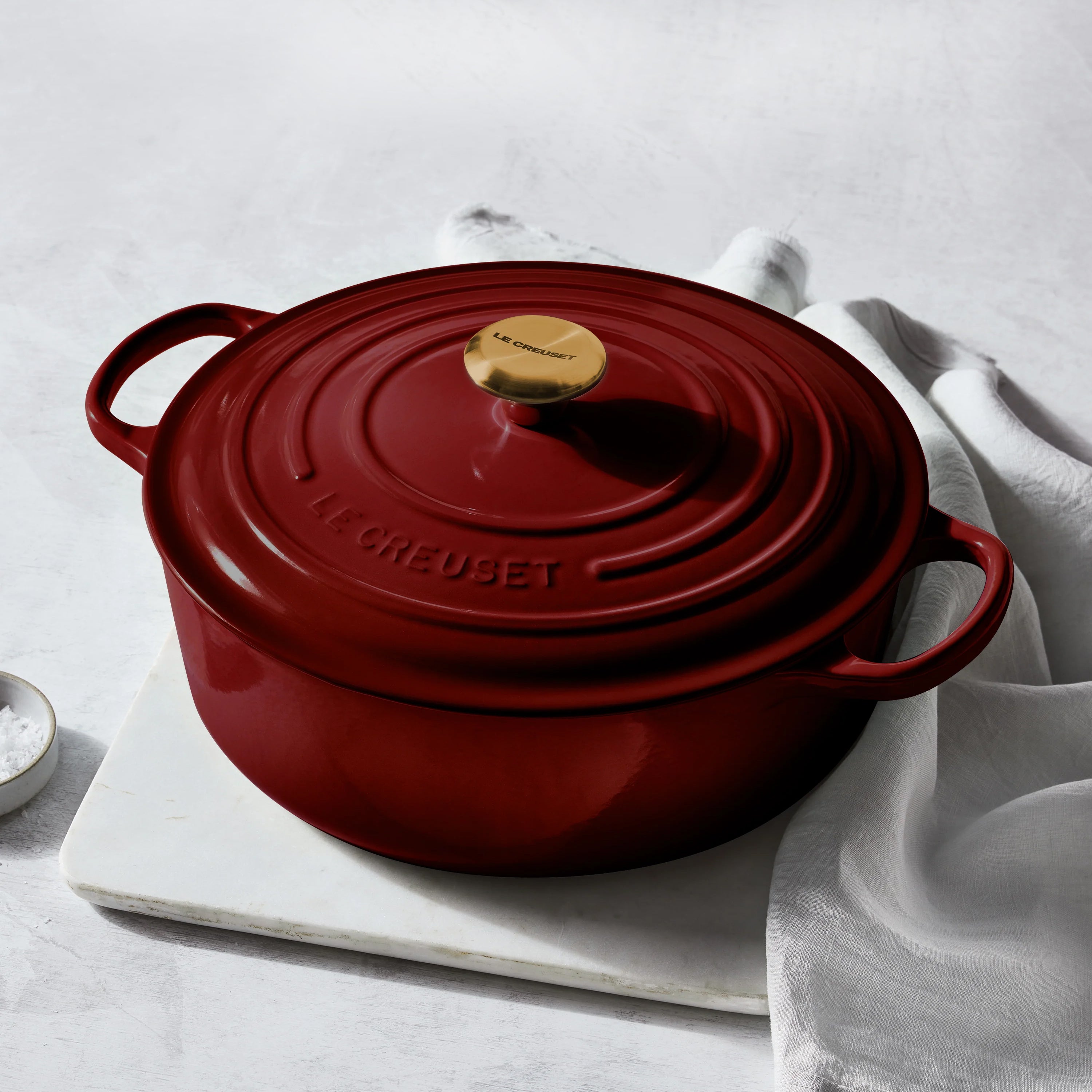 Wide-loop handles and tight-fitting lid of the Le Creuset Dutch oven in use