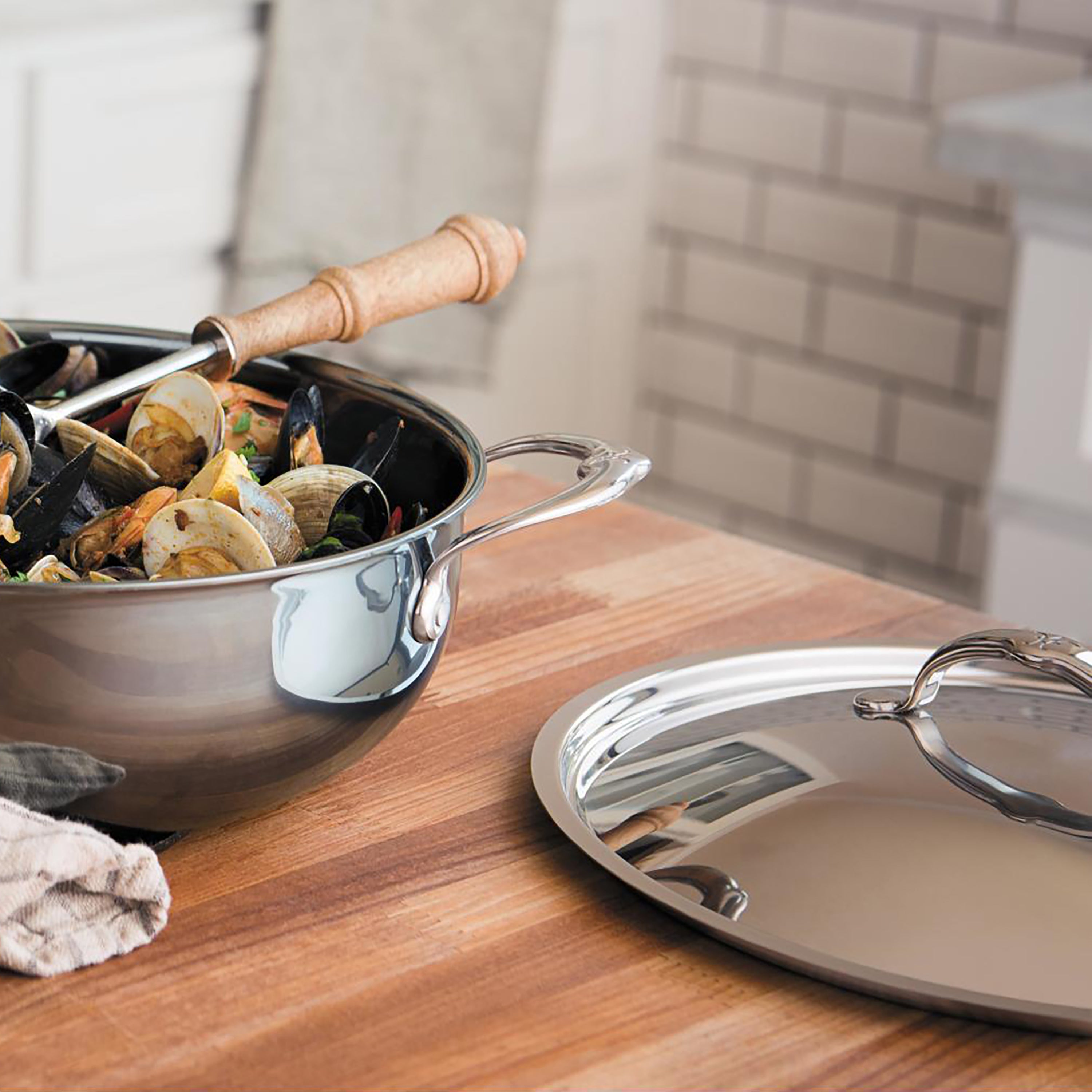 Close-up of stainless steel skillet lid resting on a skillet