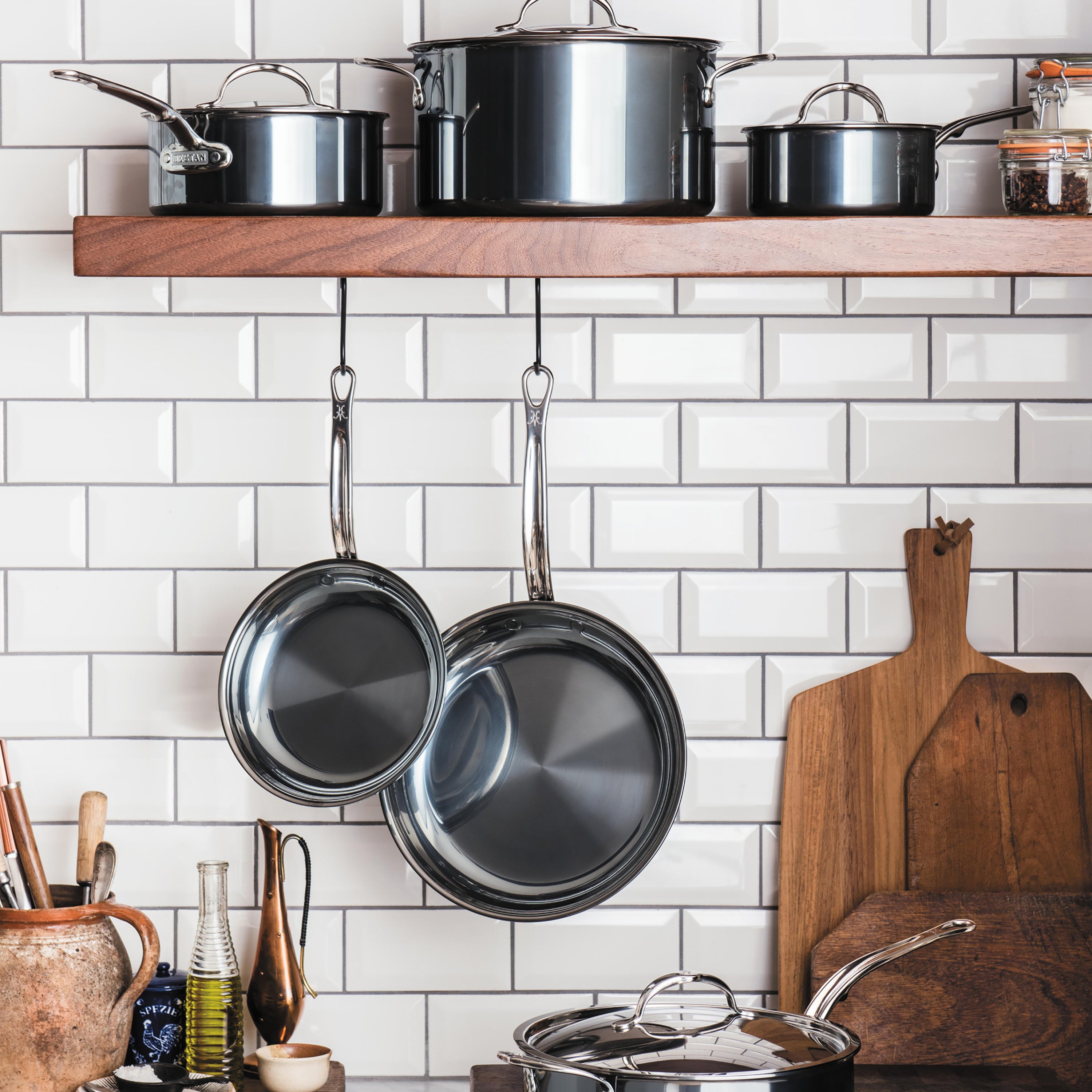 Hestan stainless steel skillet lid resting on a 12.5-inch skillet, showcasing its snug fit and premium design.