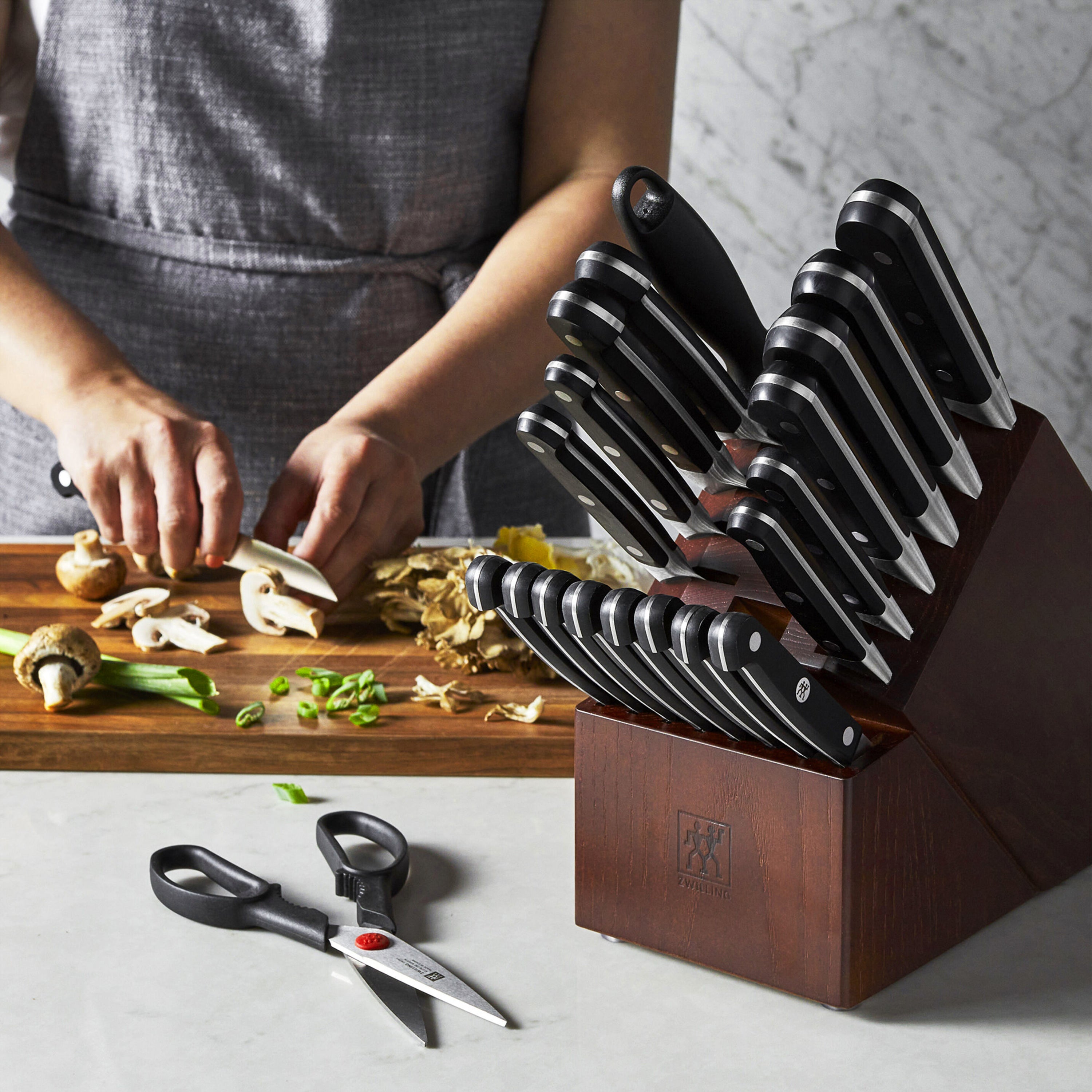 Elegant walnut knife block showcasing its 21 slots for knives and kitchen tools.