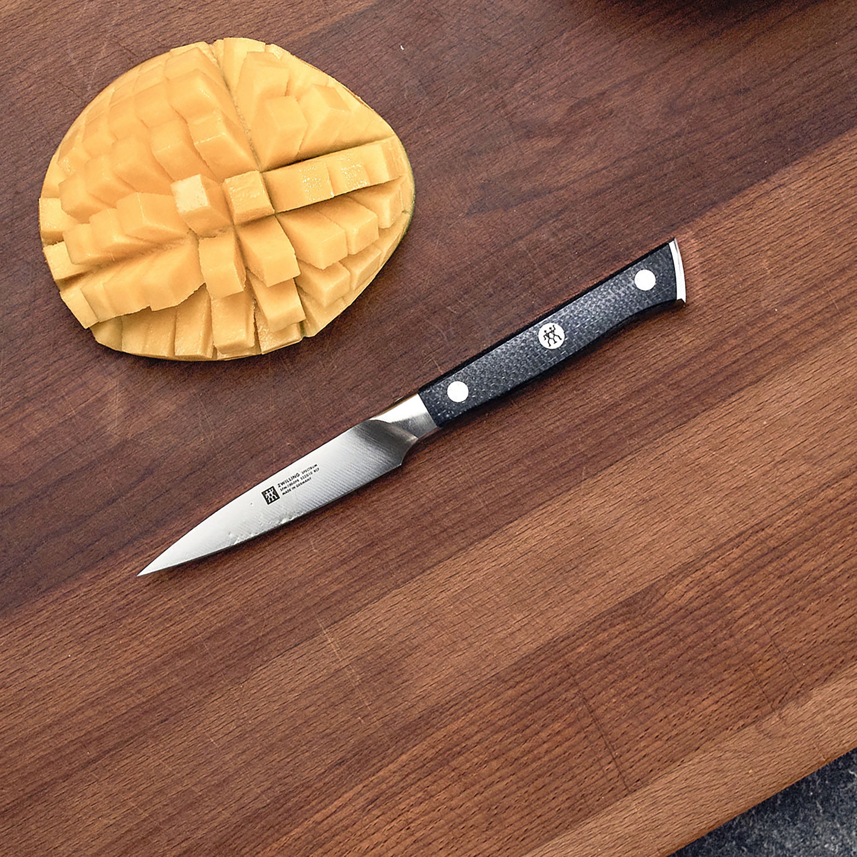 Close-up of the Zwilling Spectrum 4" paring knife blade, highlighting its sharp edge and craftsmanship.