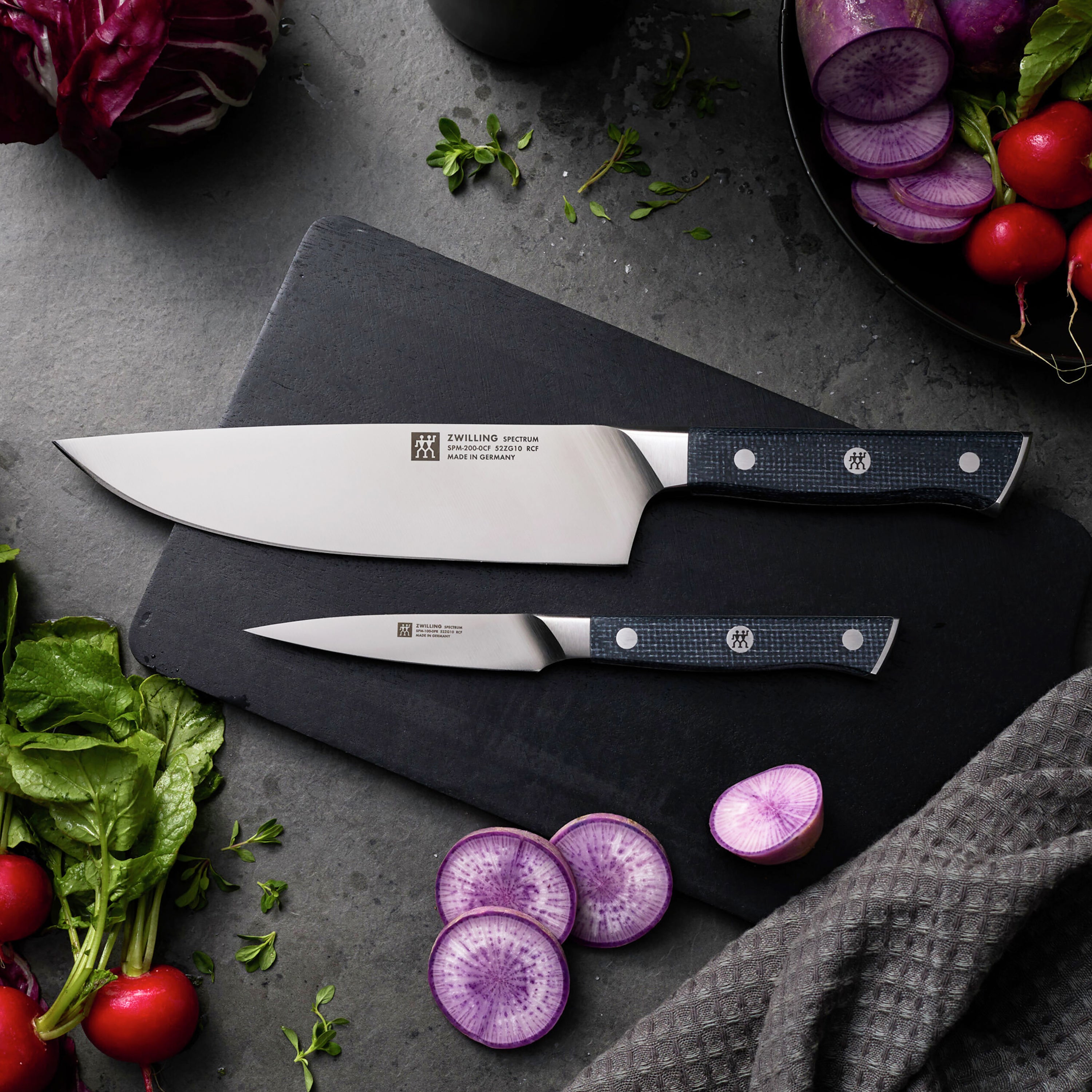 Close-up of Zwilling Spectrum handle showing triple rivets and logo