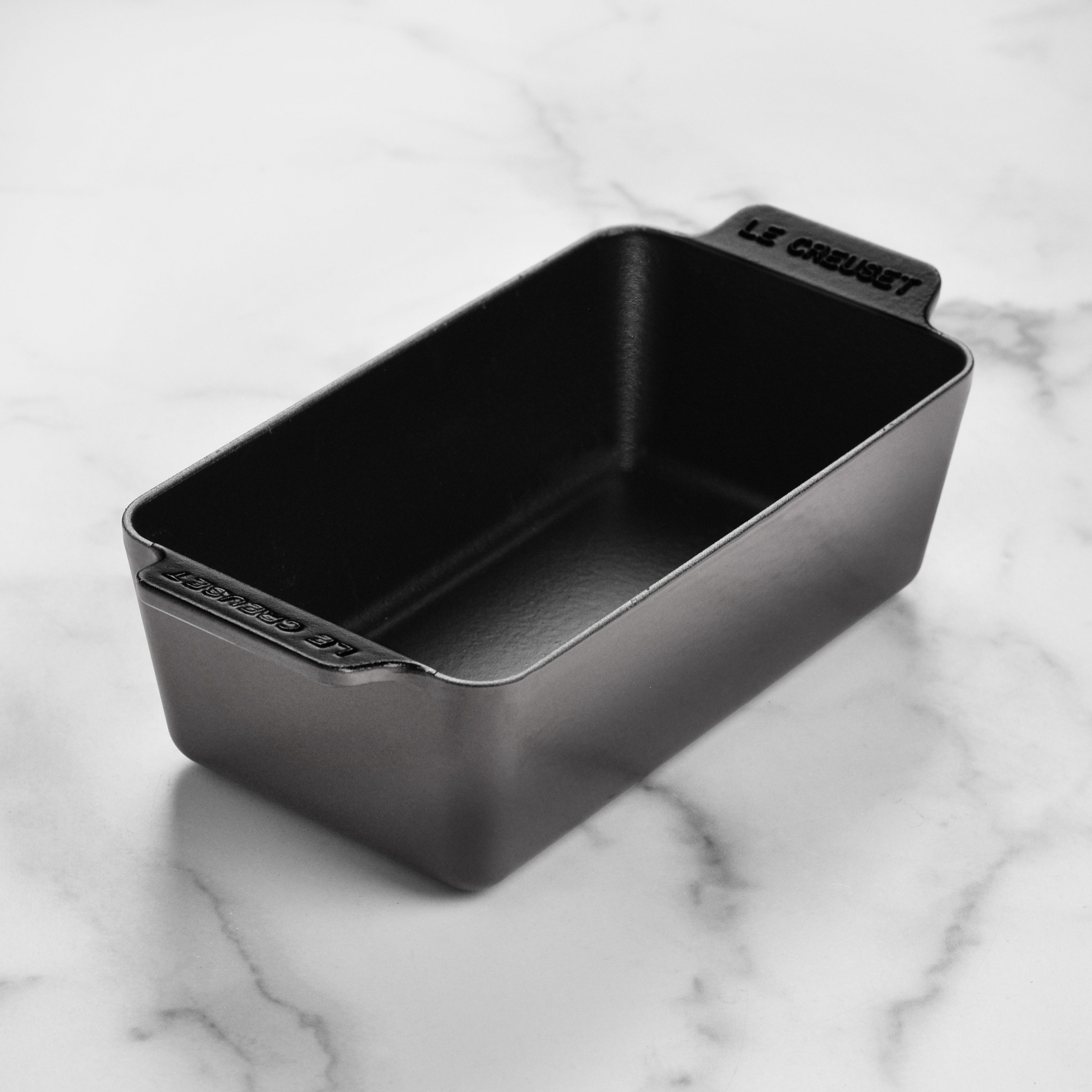 Signature enameled cast iron loaf pan from above, highlighting its durable finish and spacious interior for baking.