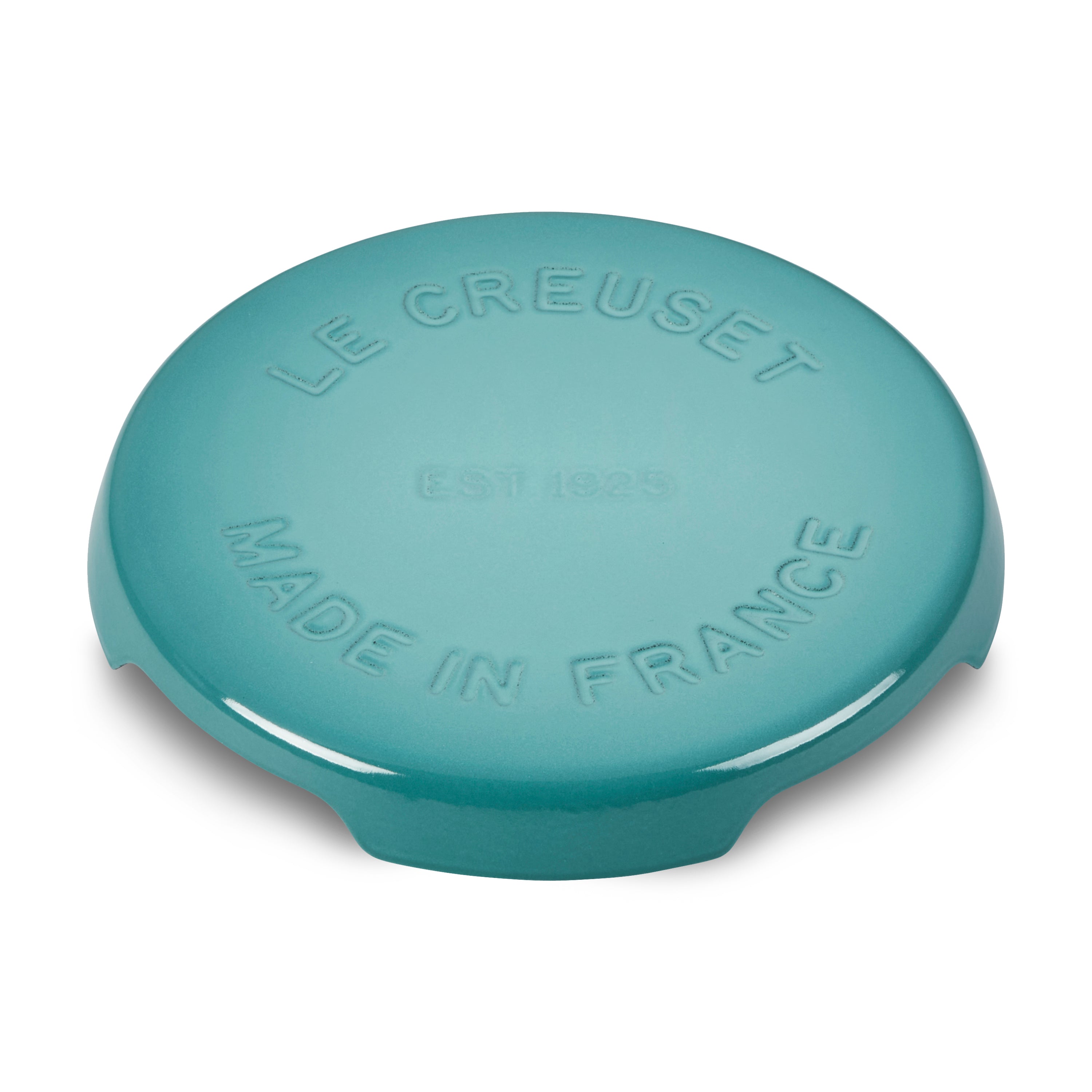 Le Creuset cast iron trivet showcasing its elegant design and vibrant Caribbean color.