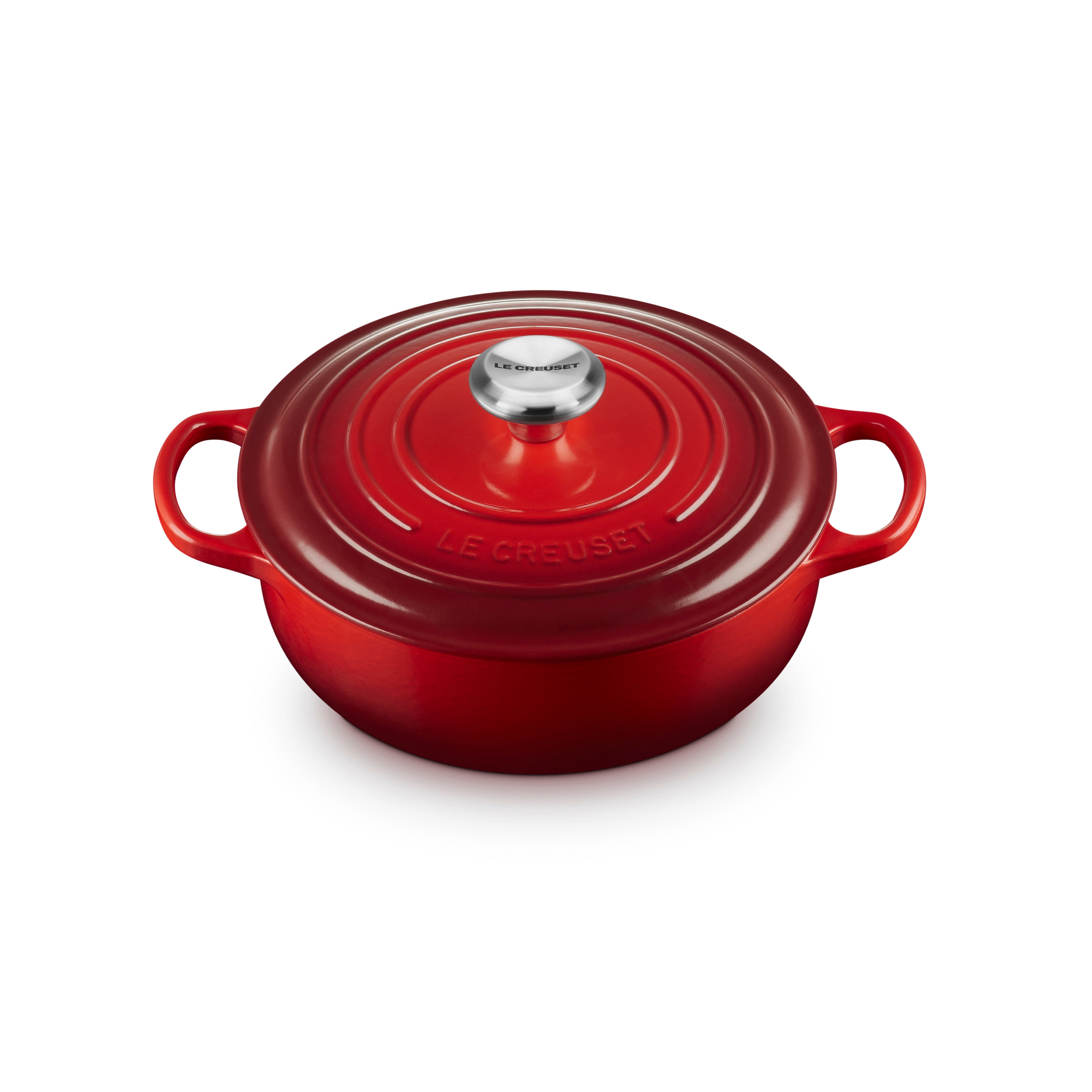 Top-down view of Cerise Le Creuset 3.5-quart Dutch oven with lid on stovetop