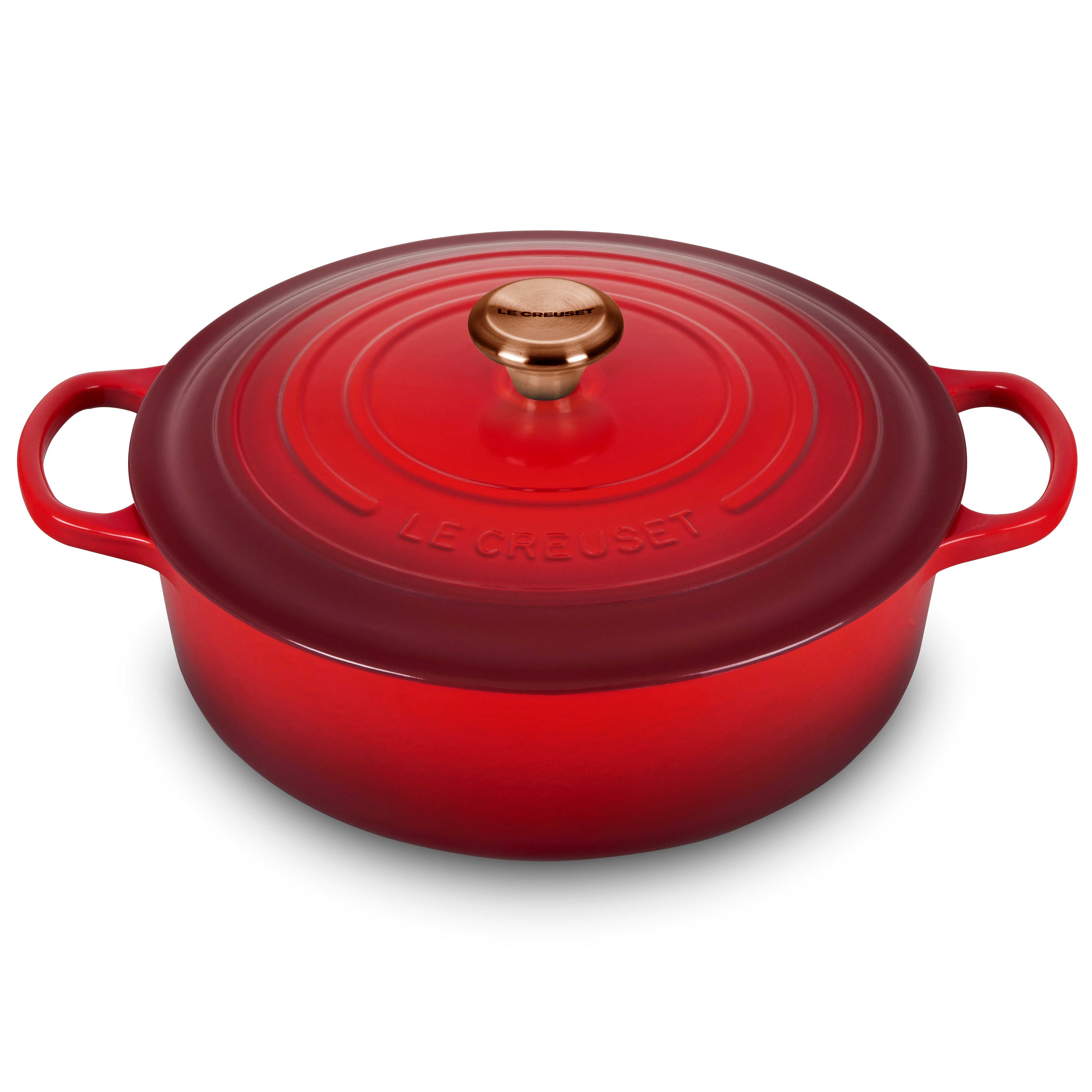 Le Creuset cast iron dutch oven showing its vibrant Cerise enamel finish and copper knob
