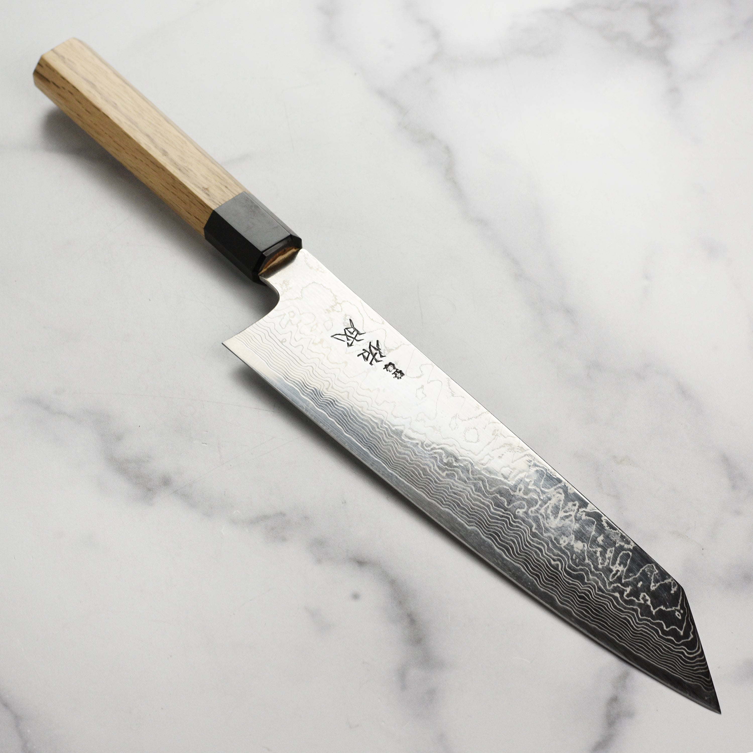 Sukenari SG2 Damascus kiritsuke chef knife showcasing blade and handle design.