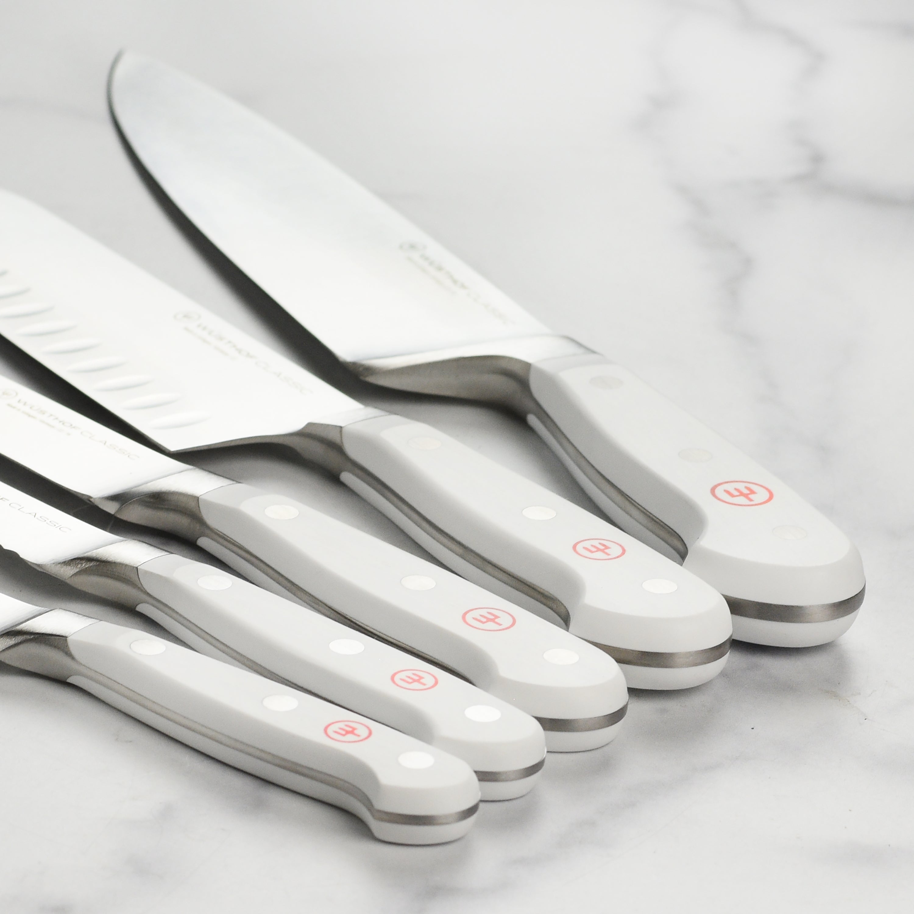 Home cook using the knife set to prepare vegetables in the kitchen
