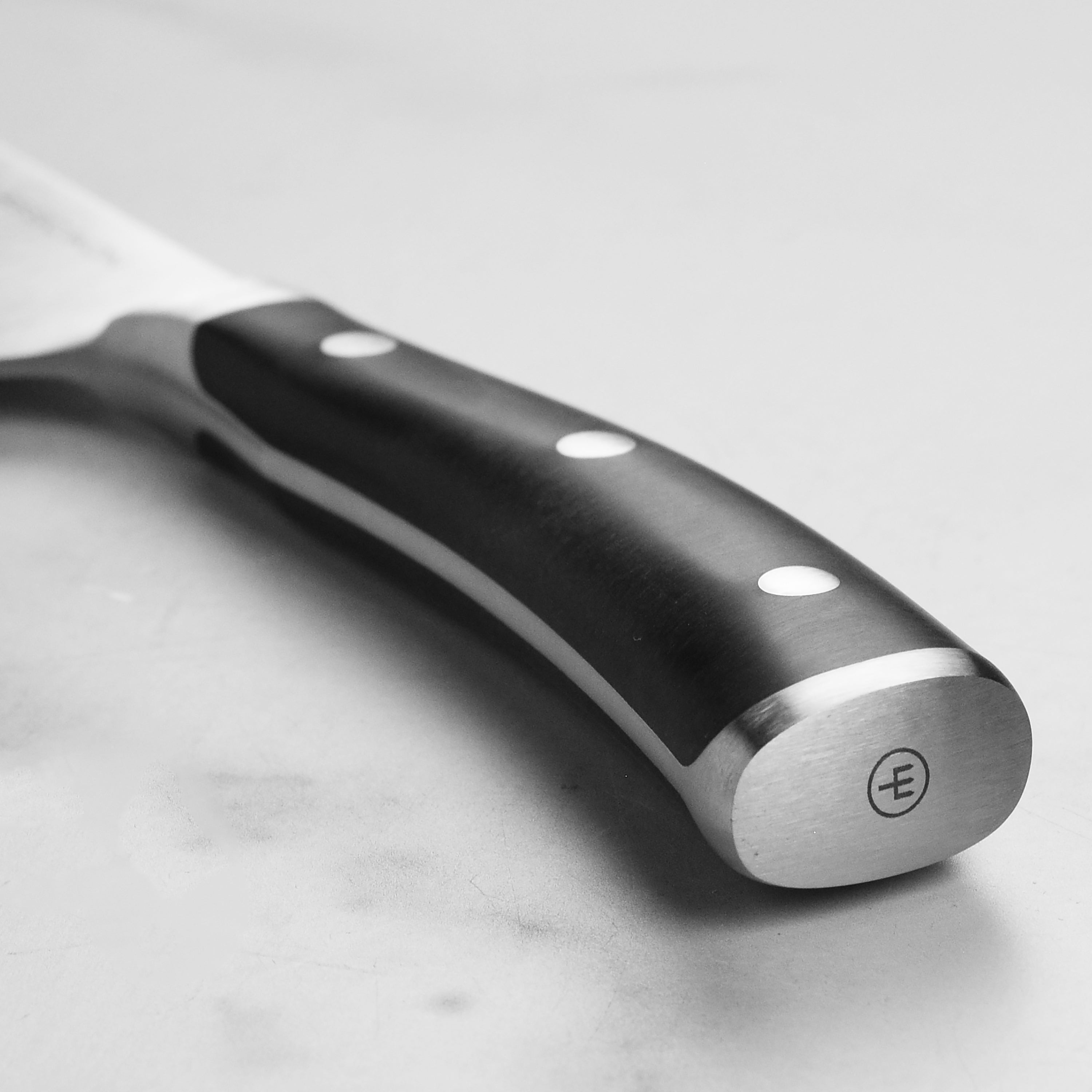 Close-up of Wusthof 7 inch Chinese chefs knife cutting vegetables with precision.