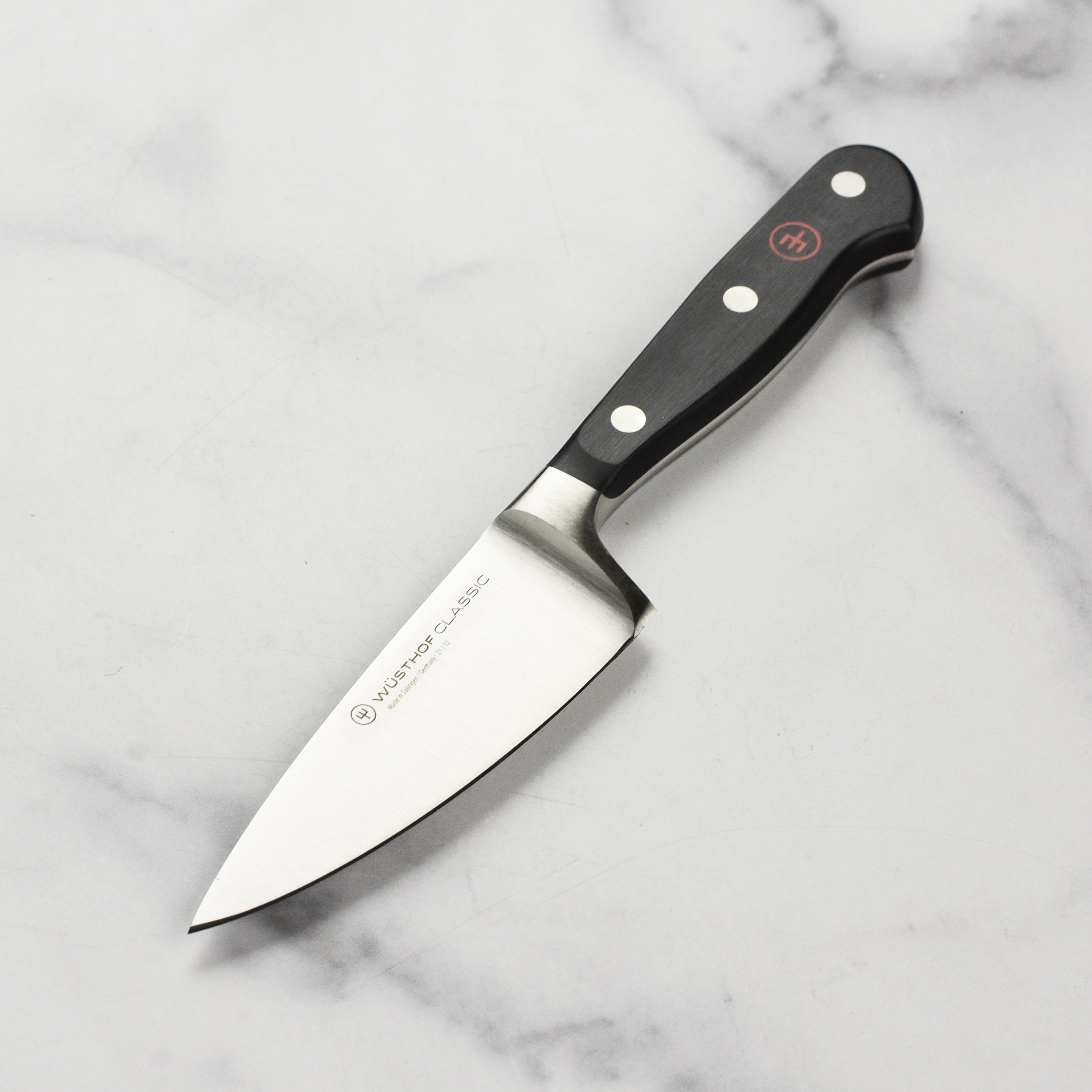 Close-up of the Wüsthof Classic 4.5-inch chef's knife blade highlighting sharpness