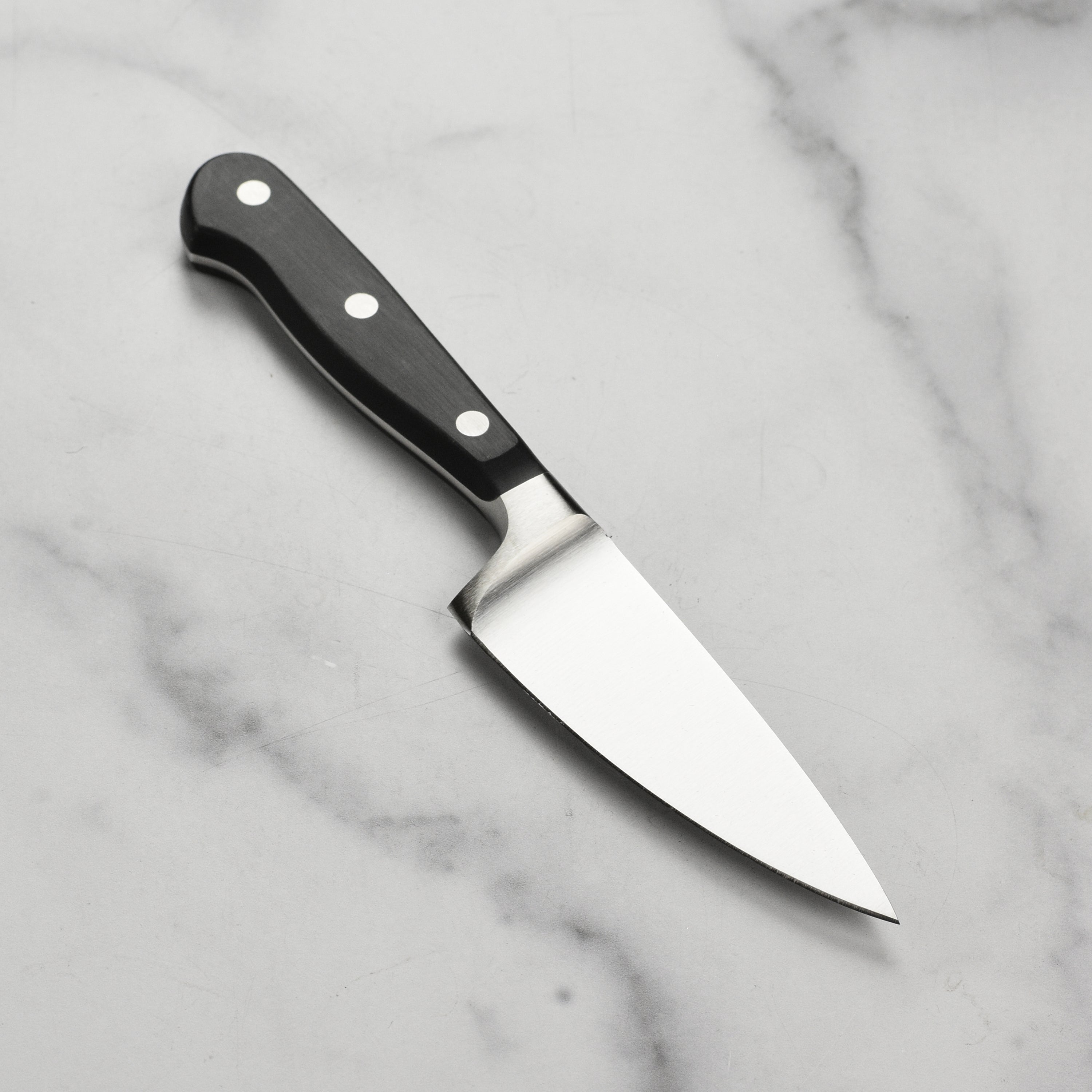 Chef using the premium German kitchen knife for slicing vegetables