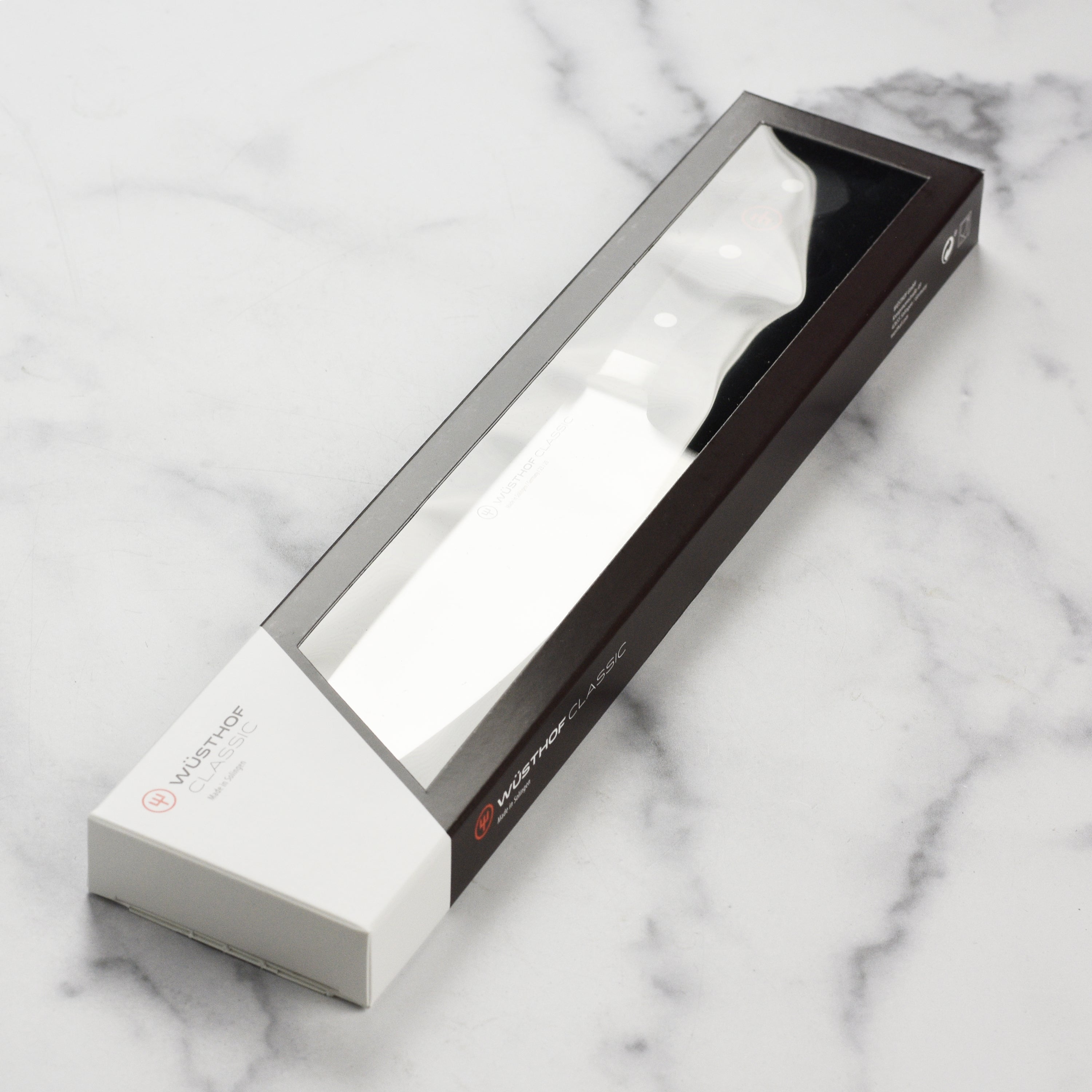 Kitchen setting displaying the Wusthof Classic chefs knife slicing vegetables effortlessly