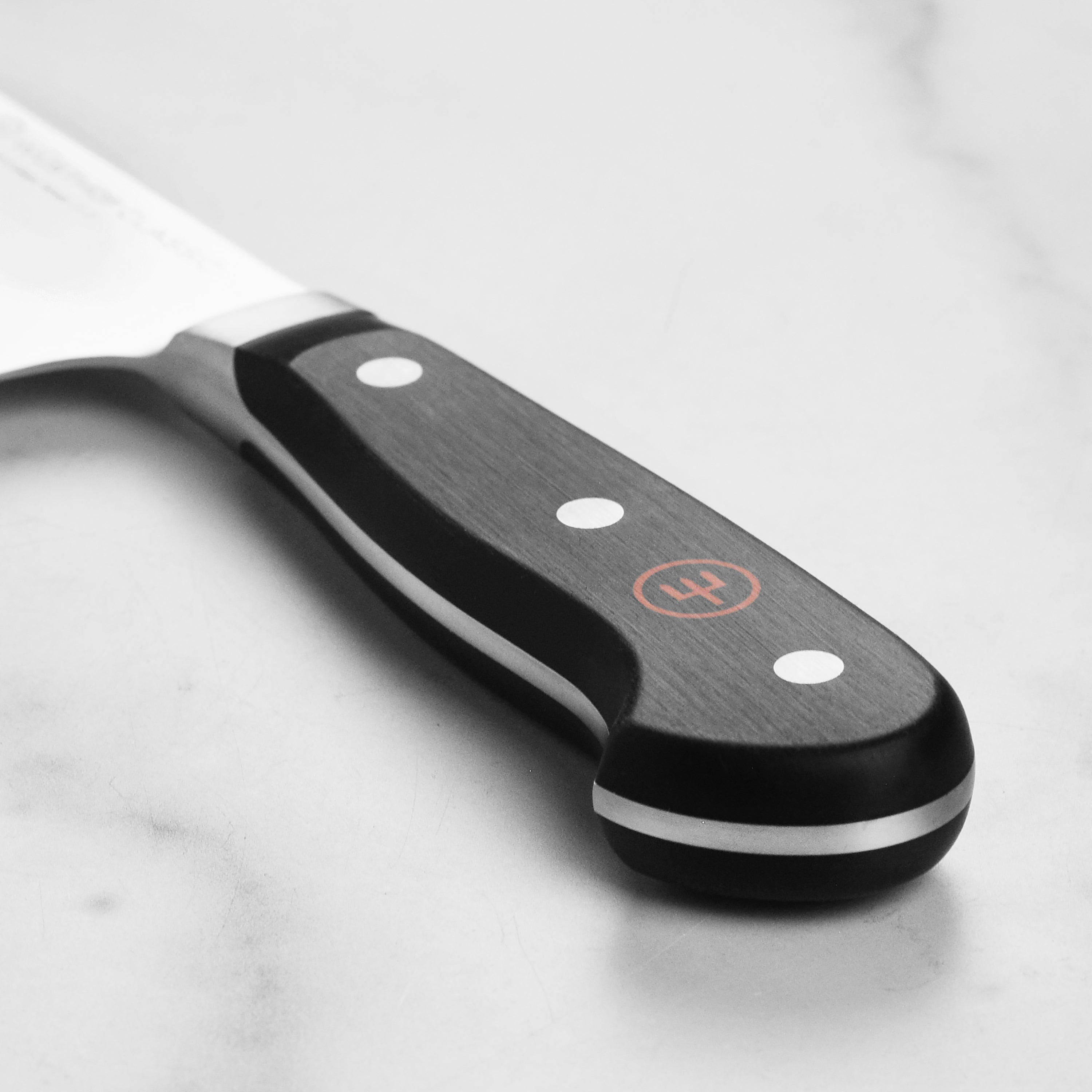 Wusthof Classic 6-Inch Chefs Knife being used for precision cutting of vegetables in a kitchen setting.