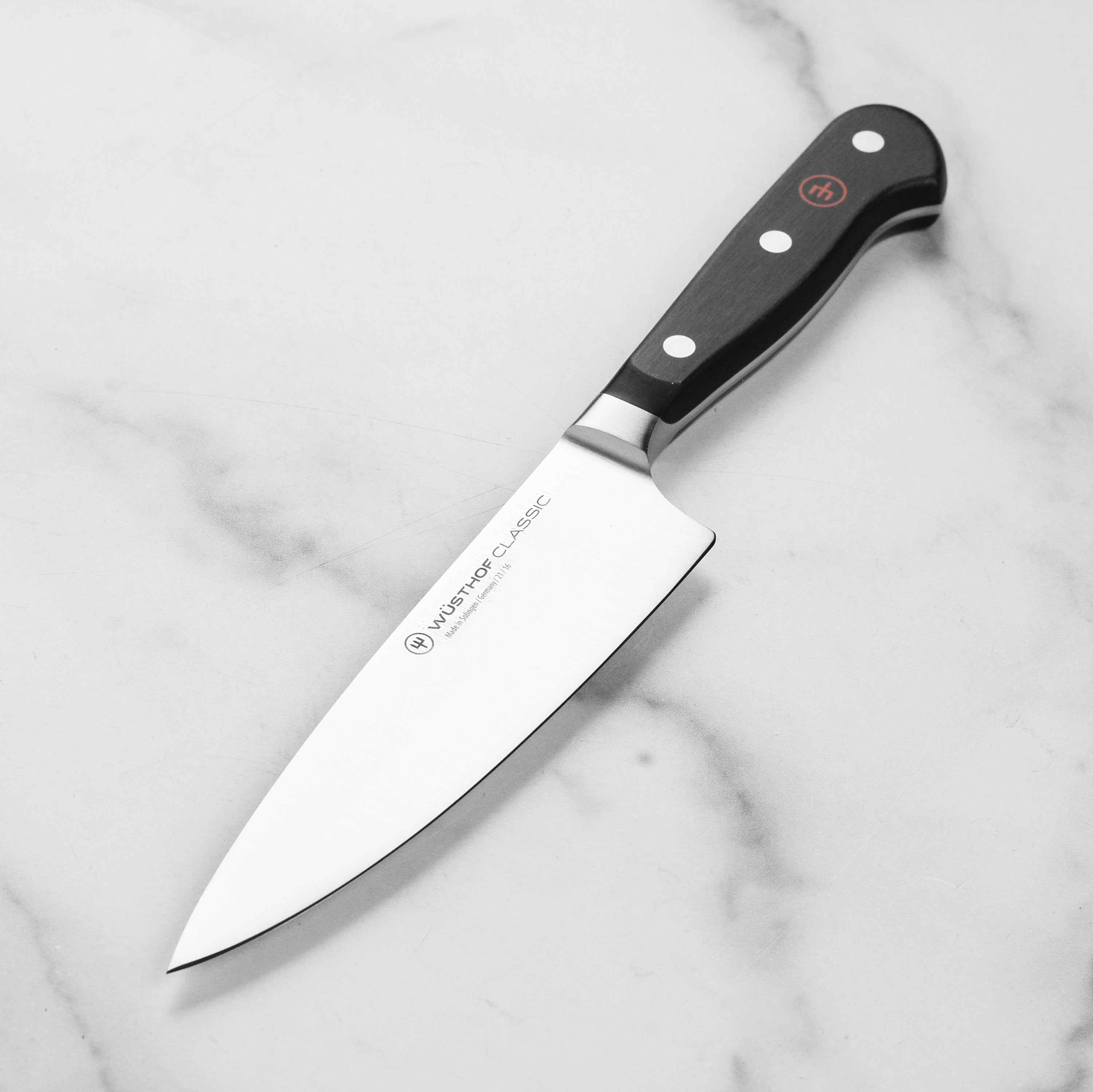 Wusthof Classic 6-Inch Chef's Knife angled view highlighting the sharp blade and ergonomic handle.