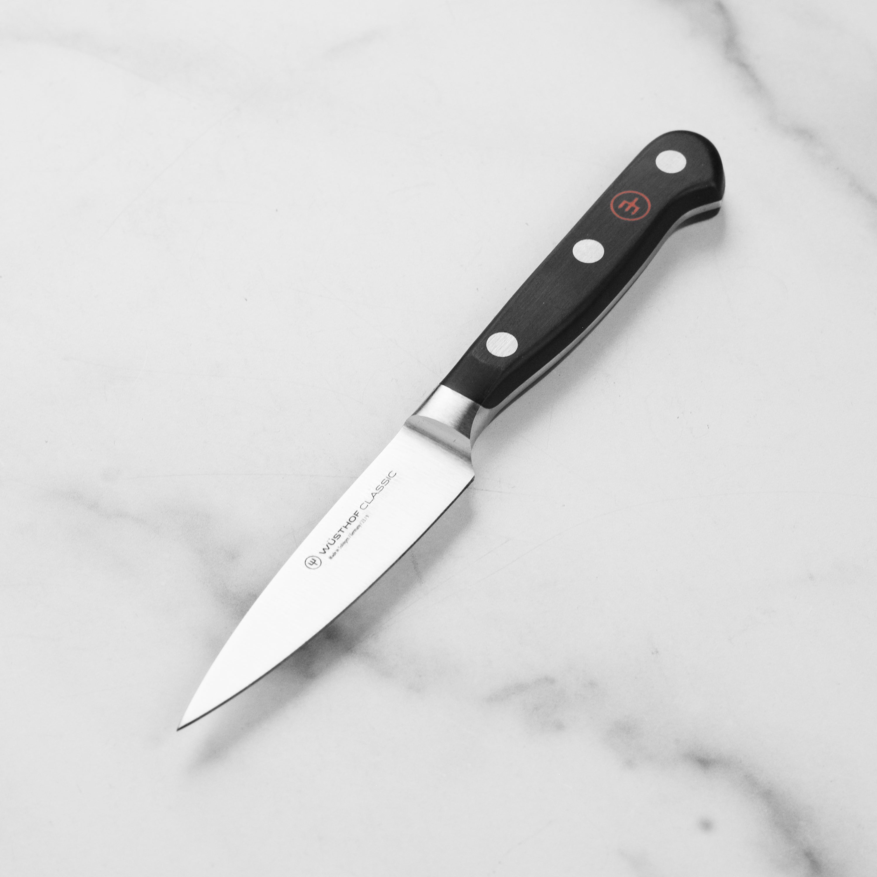Close-up of the Wusthof Classic 3.5 inch paring knife highlighting its sharp blade and half bolster design.