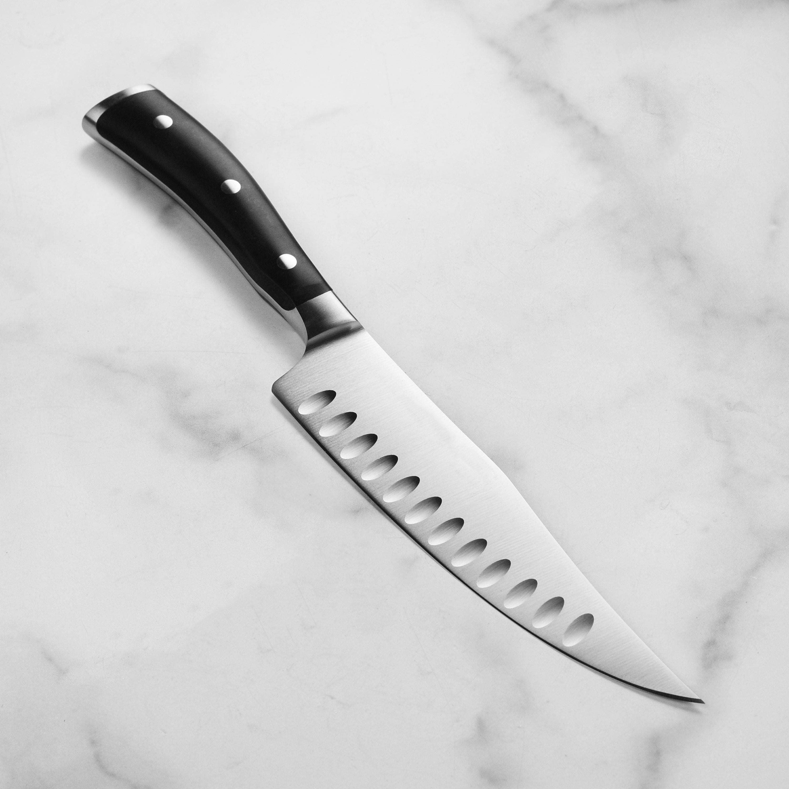 Ergonomic handle of high-carbon stainless steel kitchen knife in use