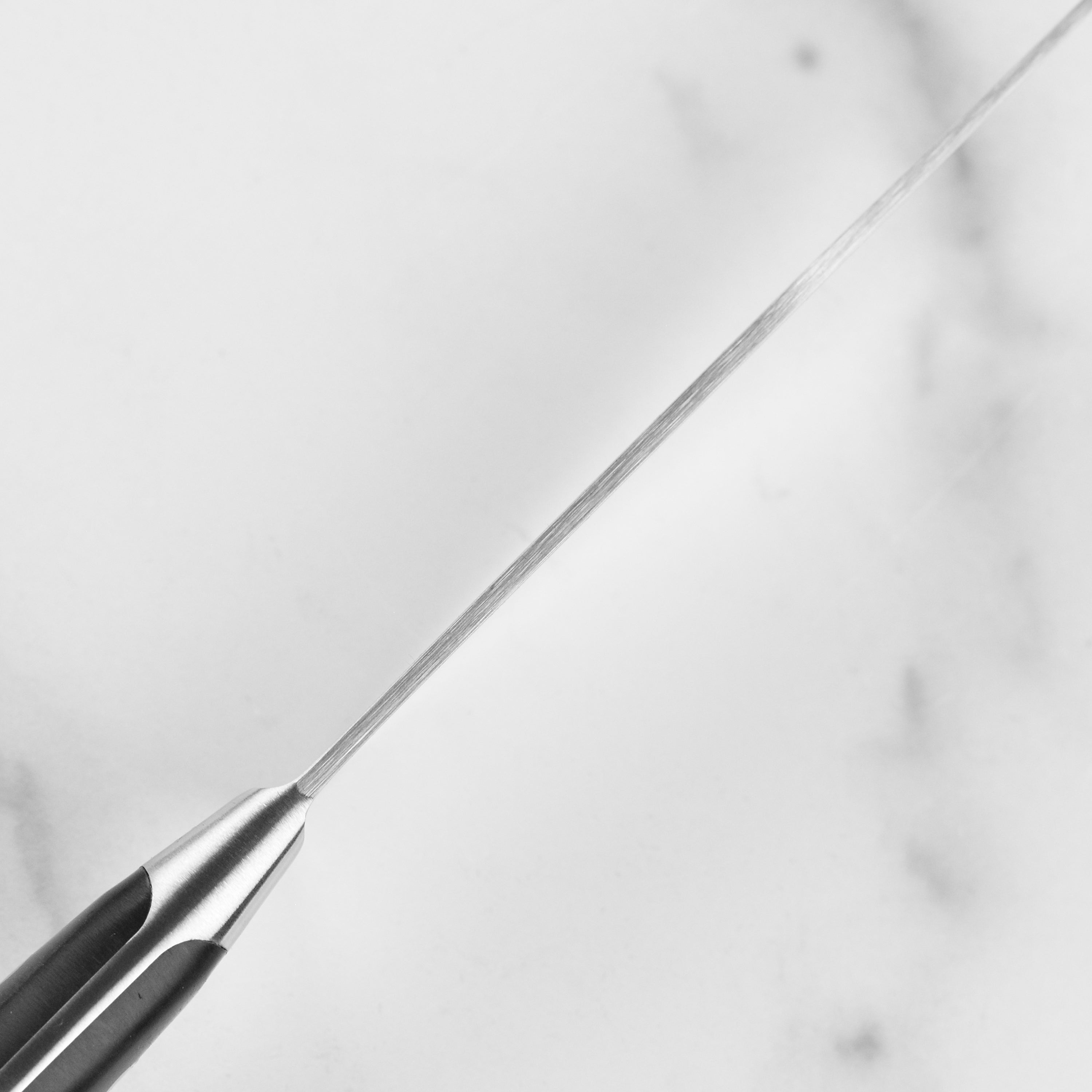 Top view of forged German chef knife highlighting its sharp edge