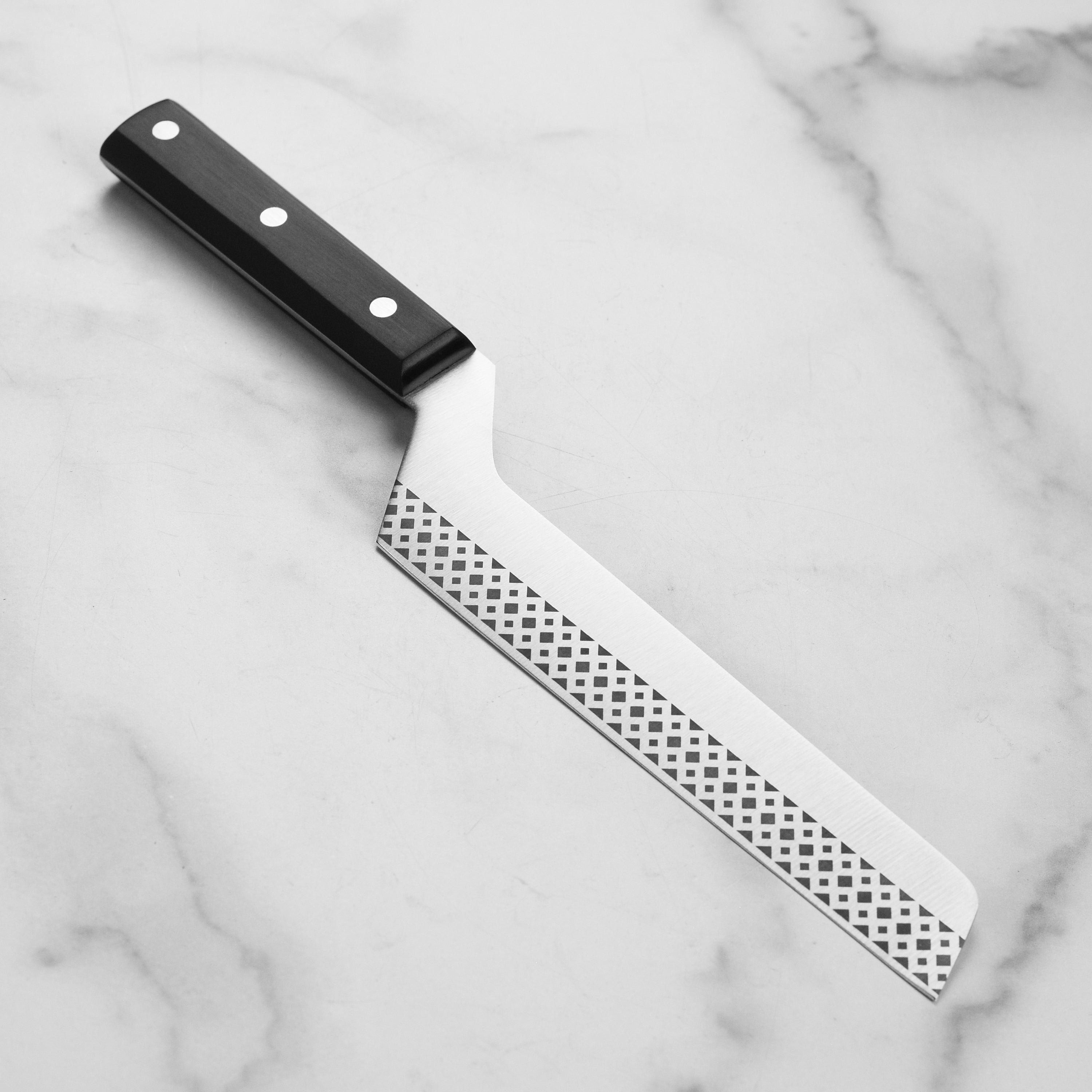 Premium German cheese knife showcasing its sharp edge and ergonomic handle.