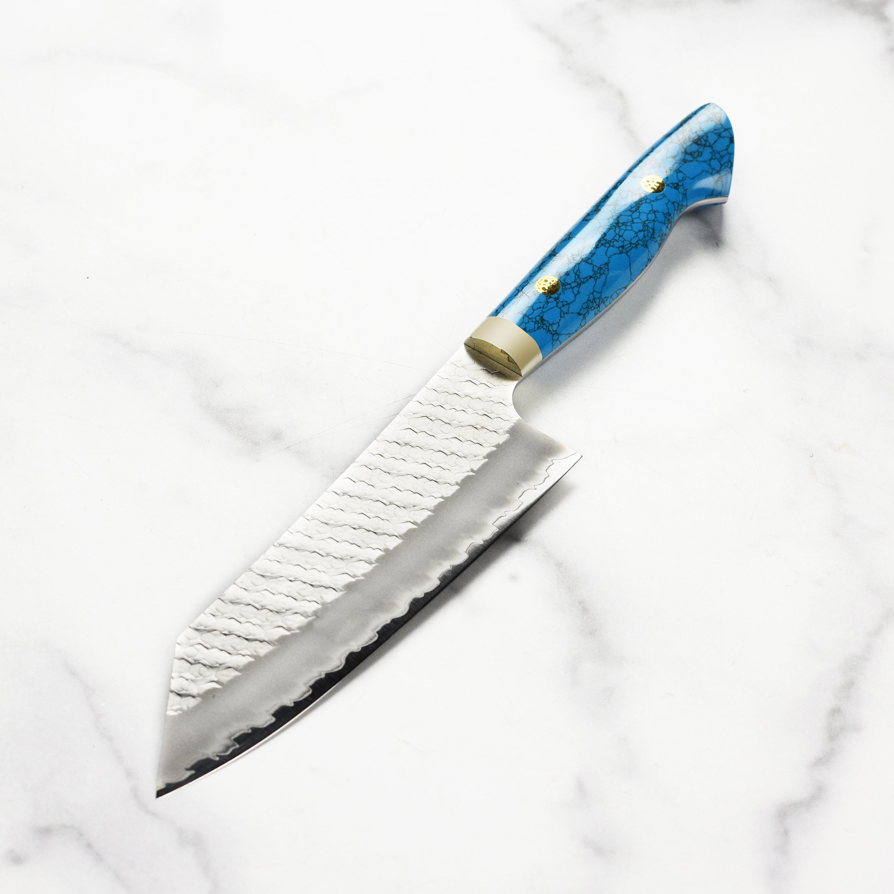 Nigara SG2 Migaki Tsuchime 7" Bunka Knife on a wooden cutting board with food prep