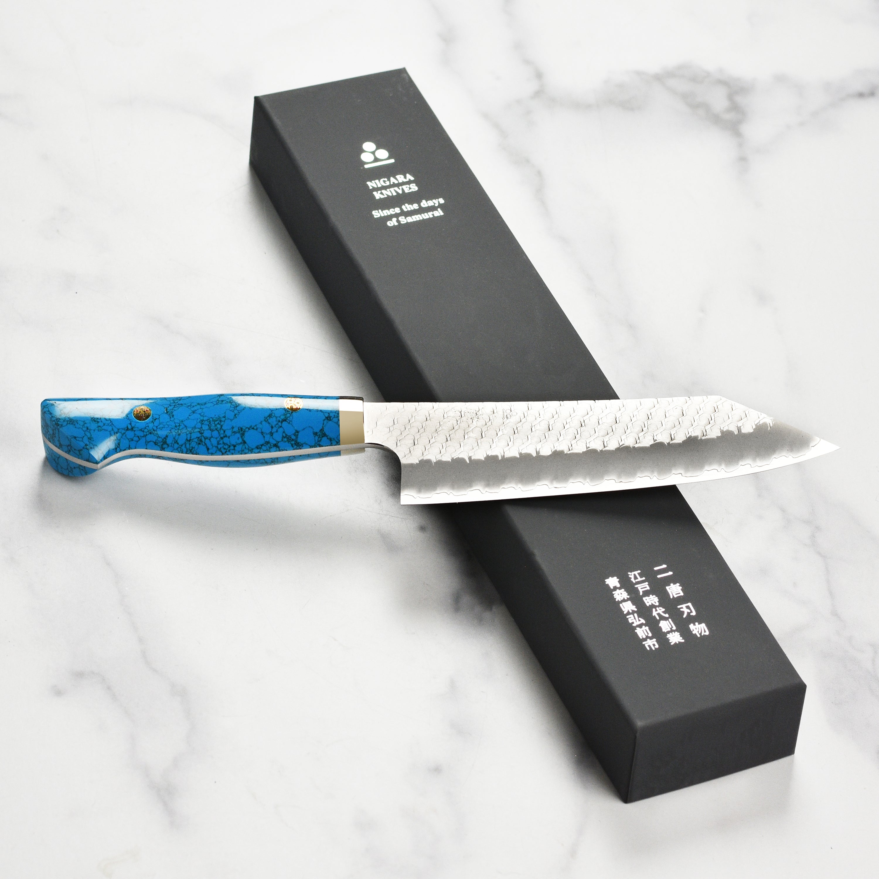Close-up of the hand-forged Japanese blade of the Nigara SG2 Migaki Tsuchime Bunka Knife